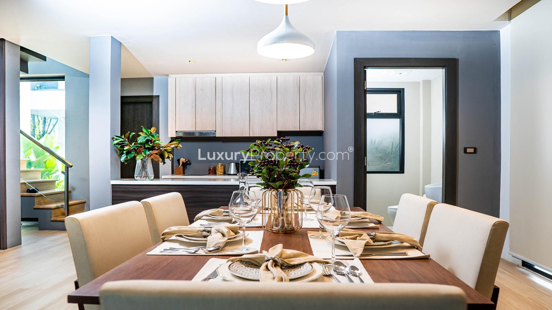 Modern living room in Phuket villa, featuring sleek TV unit and plush seating