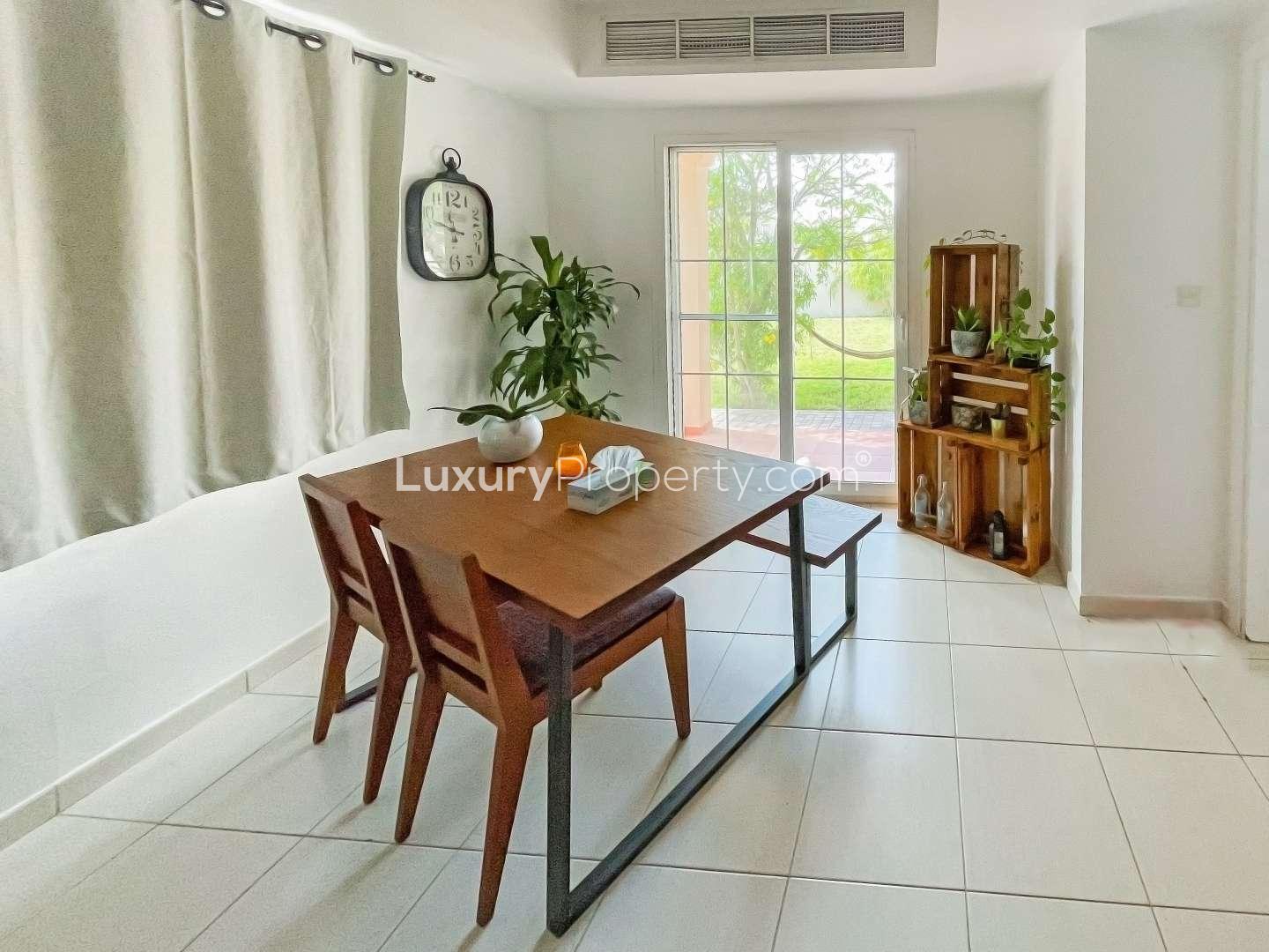 Living room of 2-bedroom villa in Springs 11, Emirates Living, with modern decor and dining area