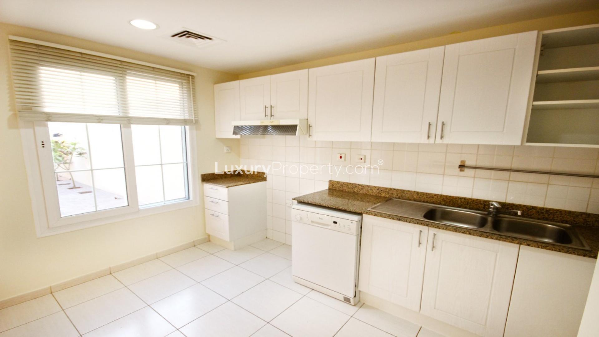 "Modern kitchen in 2-bedroom villa for sale, The Springs community, LP16253 listing.",Modern kitchen in The Springs villa with white cabinets and granite countertops