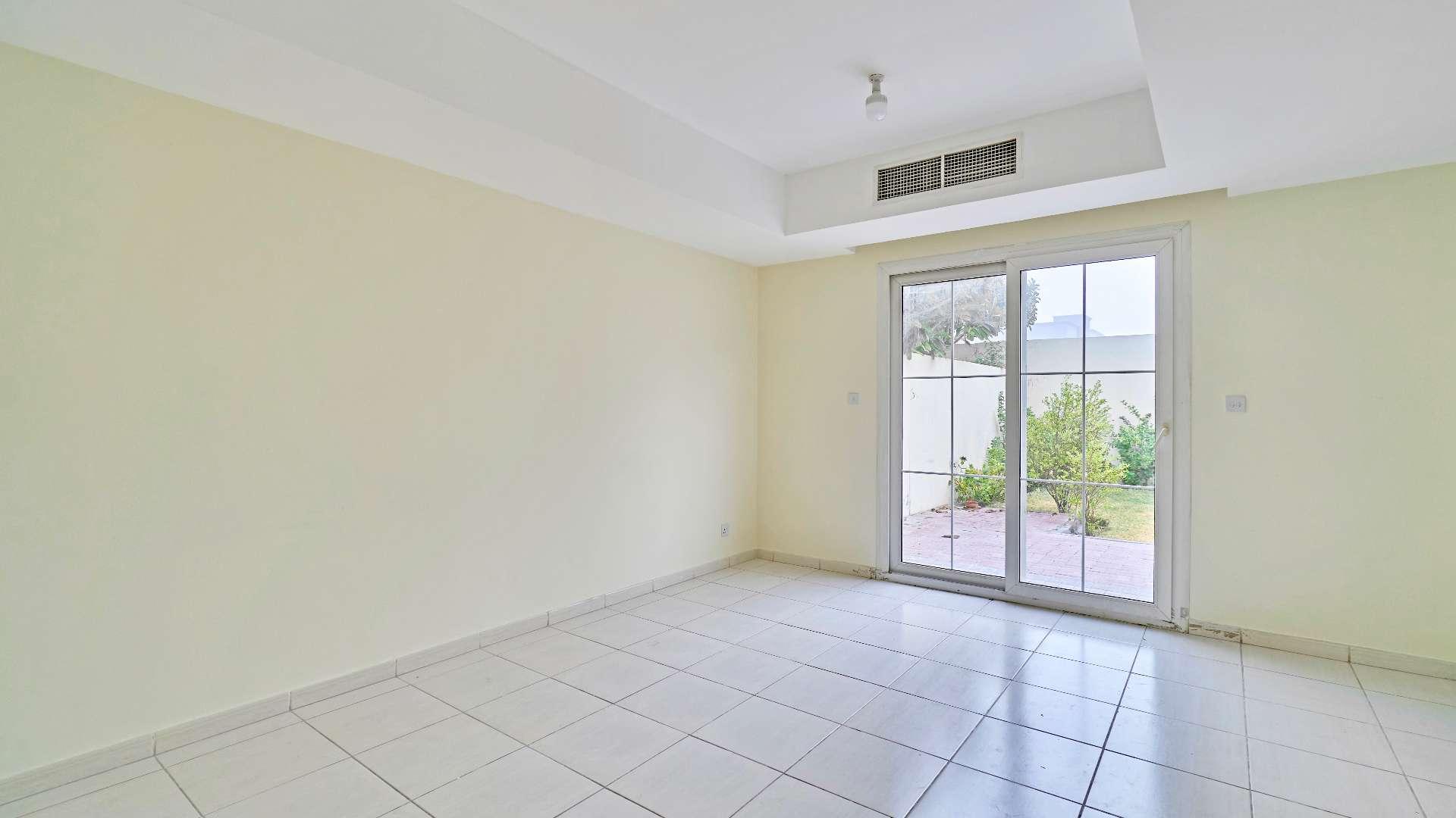 Empty living room in two-bedroom villa, tiled floor, adjacent to kitchen, Springs 14