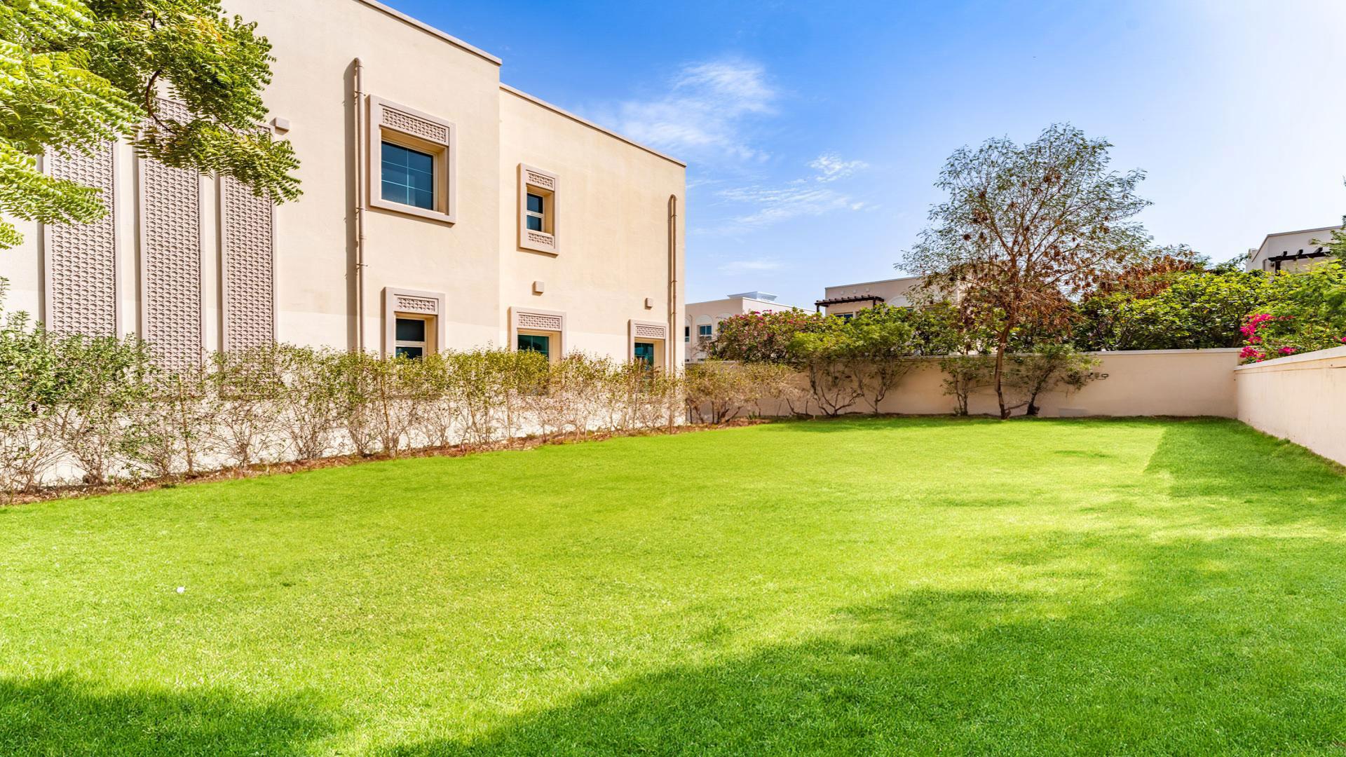 "Spacious JVT villa with lush garden, District 3C, 2 bedrooms, 3 bathrooms for sale.",Spacious backyard of JVT villa in District 3C, featuring lush green lawn