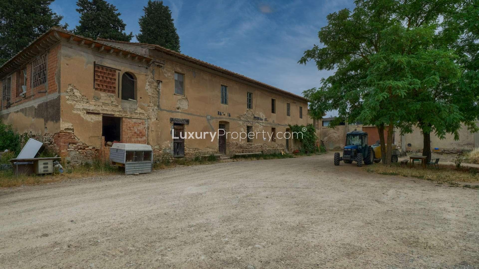Tuscan estate exterior with historic buildings, trees, and parked cars in Florence, Borgo Rosa Antico