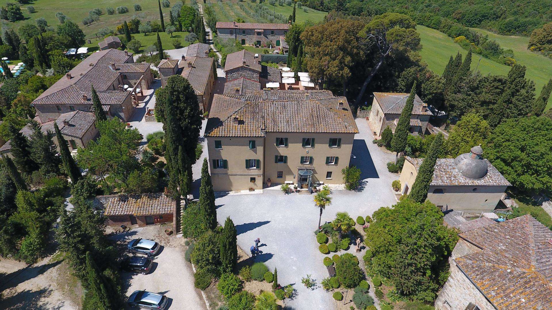 Charming stone villa in Siena's Borgo Bio community with lush gardens and rustic architecture