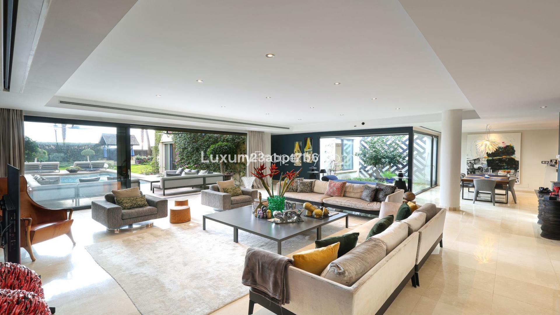 Luxurious living room in beachfront villa, Costa del Sol, with modern decor and garden view