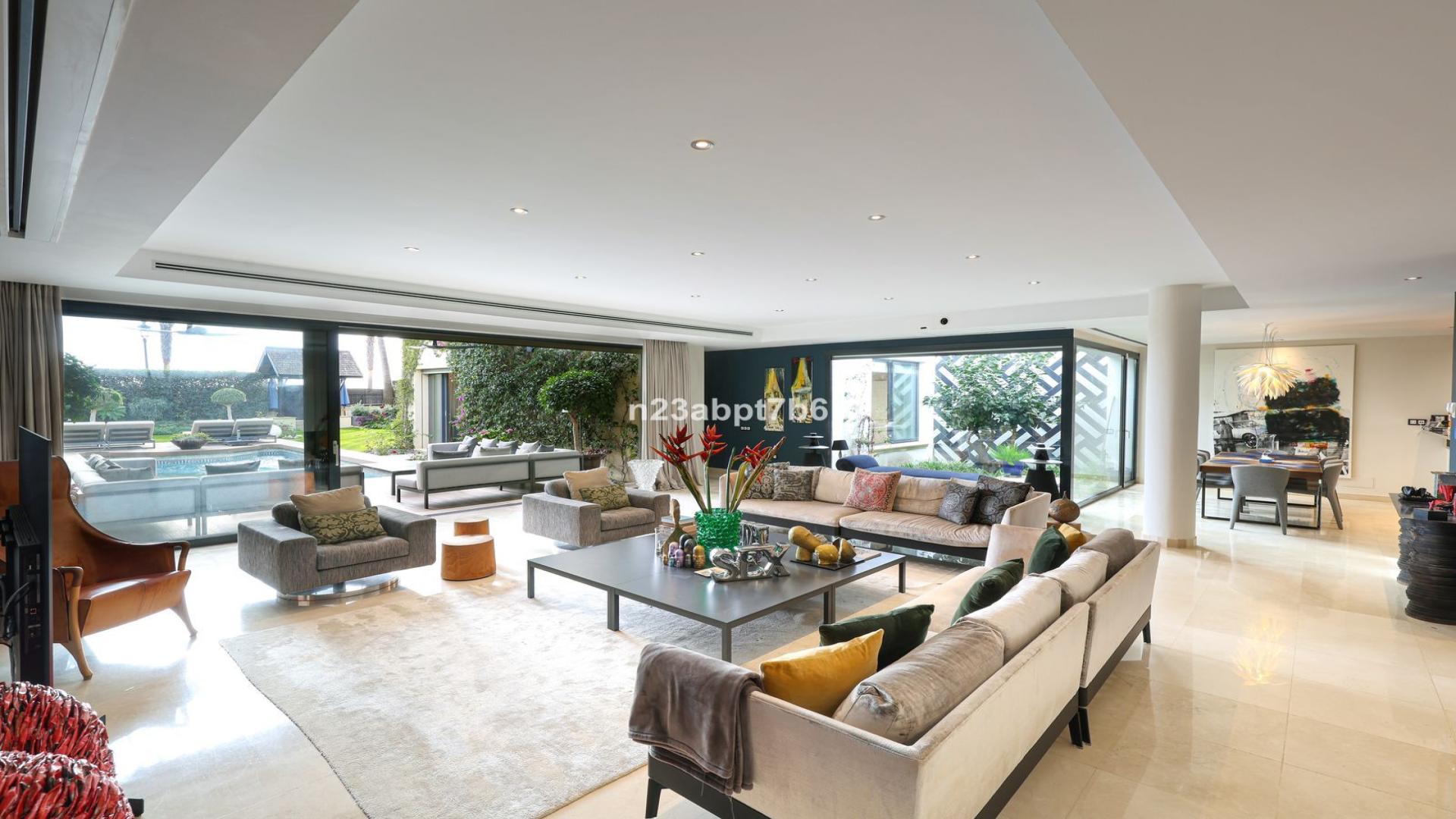 Luxurious living room in beachfront villa, Costa del Sol, with modern decor and garden view