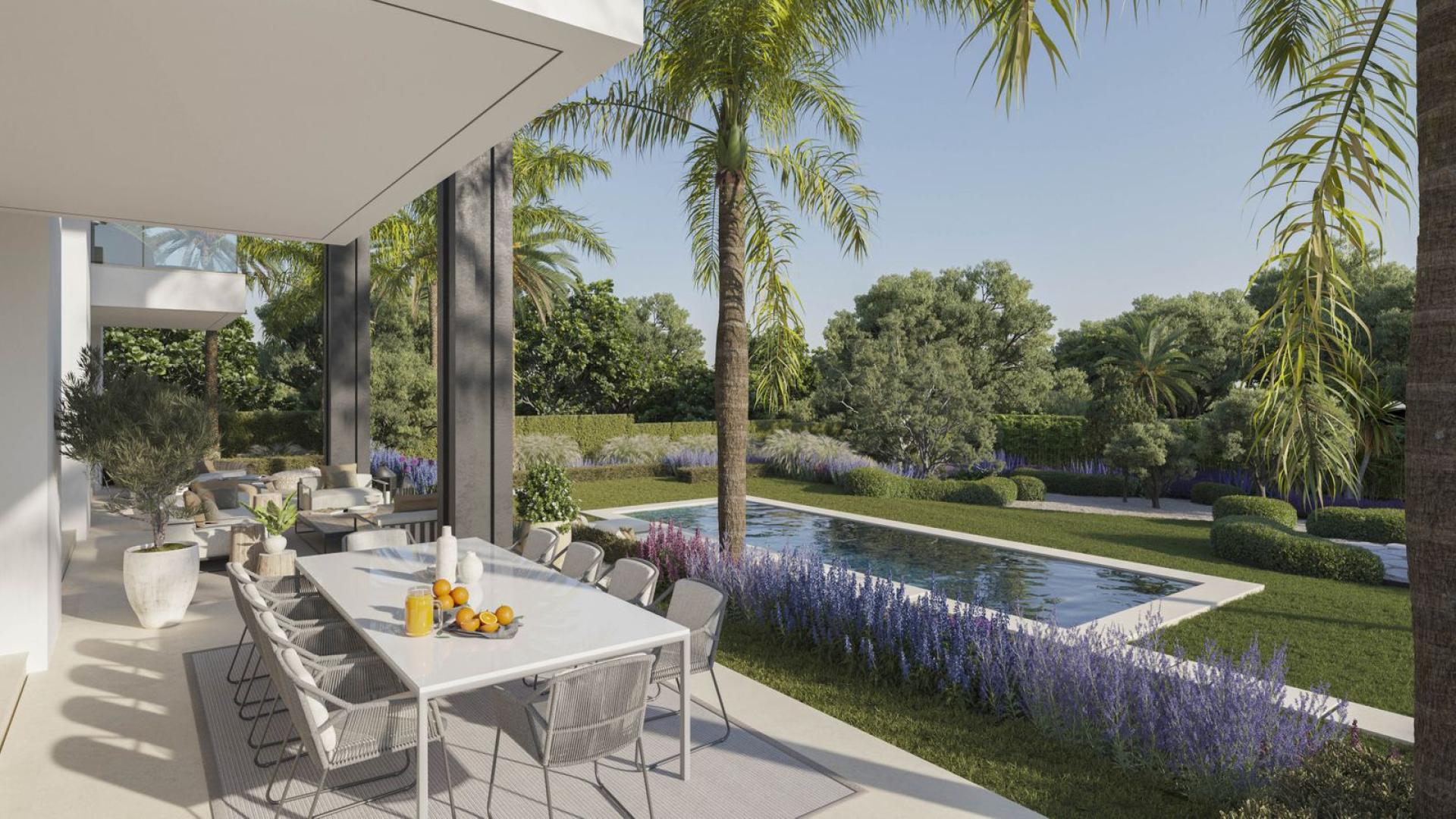 Outdoor dining area overlooking lush garden and pool in Rocio de Nagüeles villa