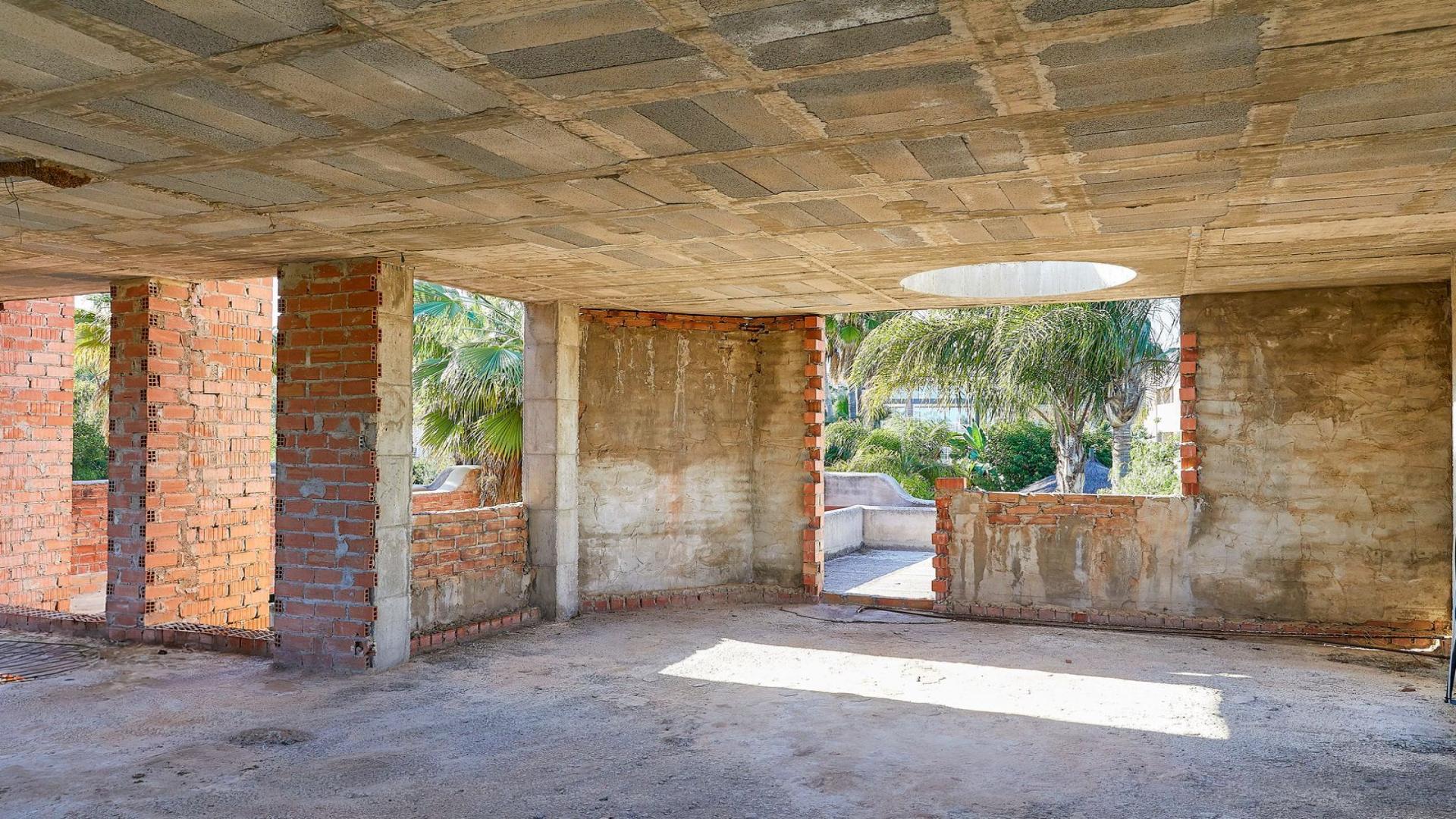 Alt text: "Unfinished brick villa construction in Atalaya de Río Verde, Marbella, for sale.",Unfinished interior of villa for sale in Atalaya de Río Verde, Marbella