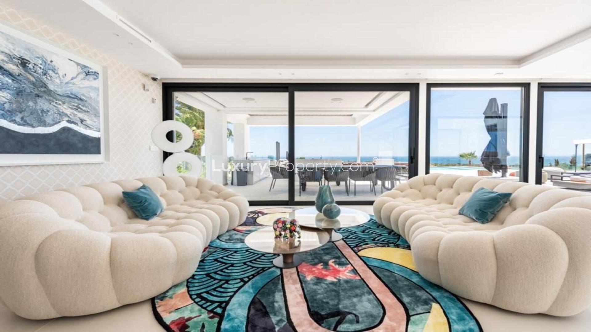 "Spacious dining area with sea view in luxurious Málaga villa for sale, New Golden Mile.",Luxurious living room with sea view in 6-bedroom villa, New Golden Mile, Málaga