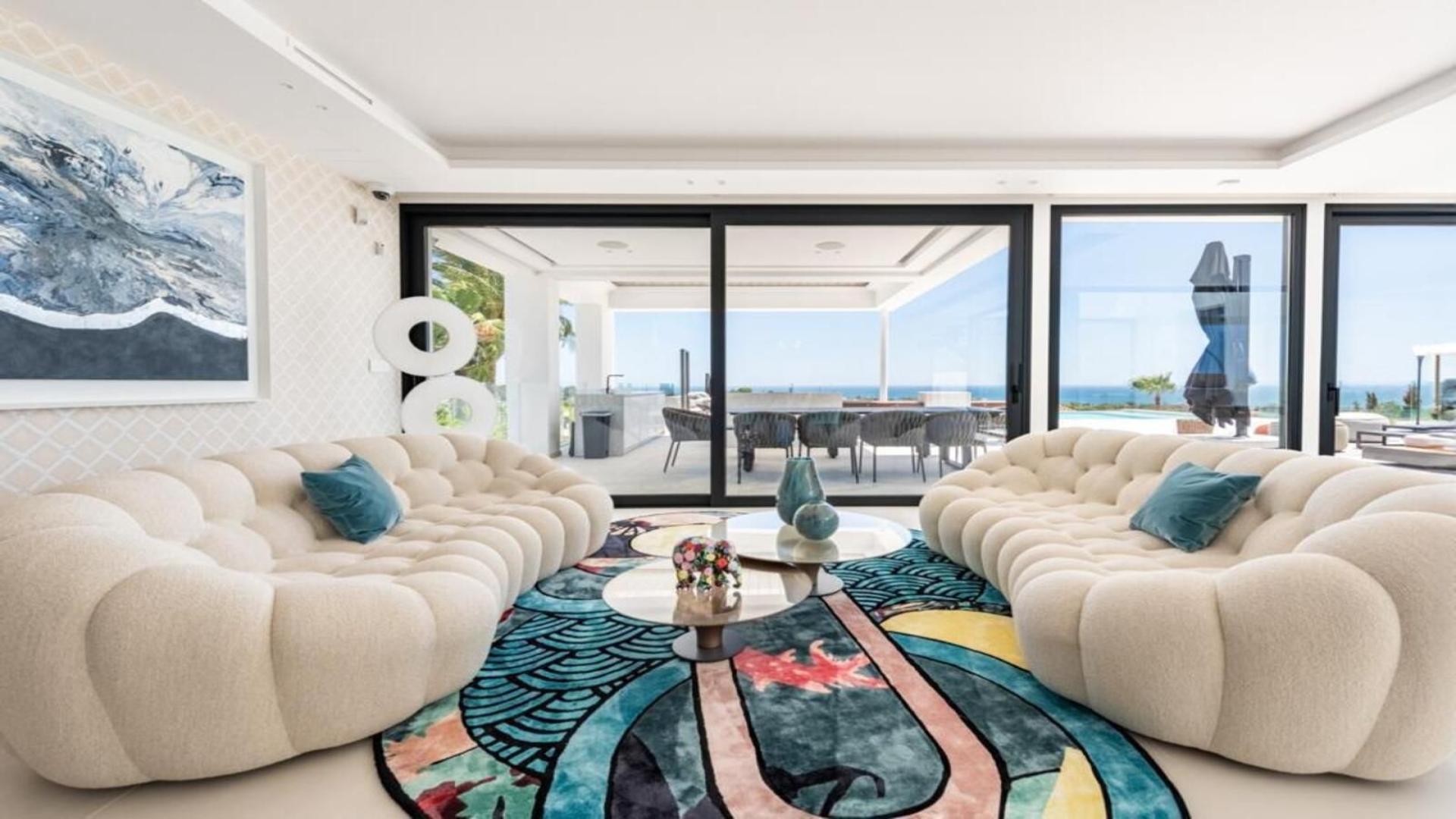 "Spacious dining area with sea view in luxurious Málaga villa for sale, New Golden Mile.",Luxurious living room with sea view in 6-bedroom villa, New Golden Mile, Málaga