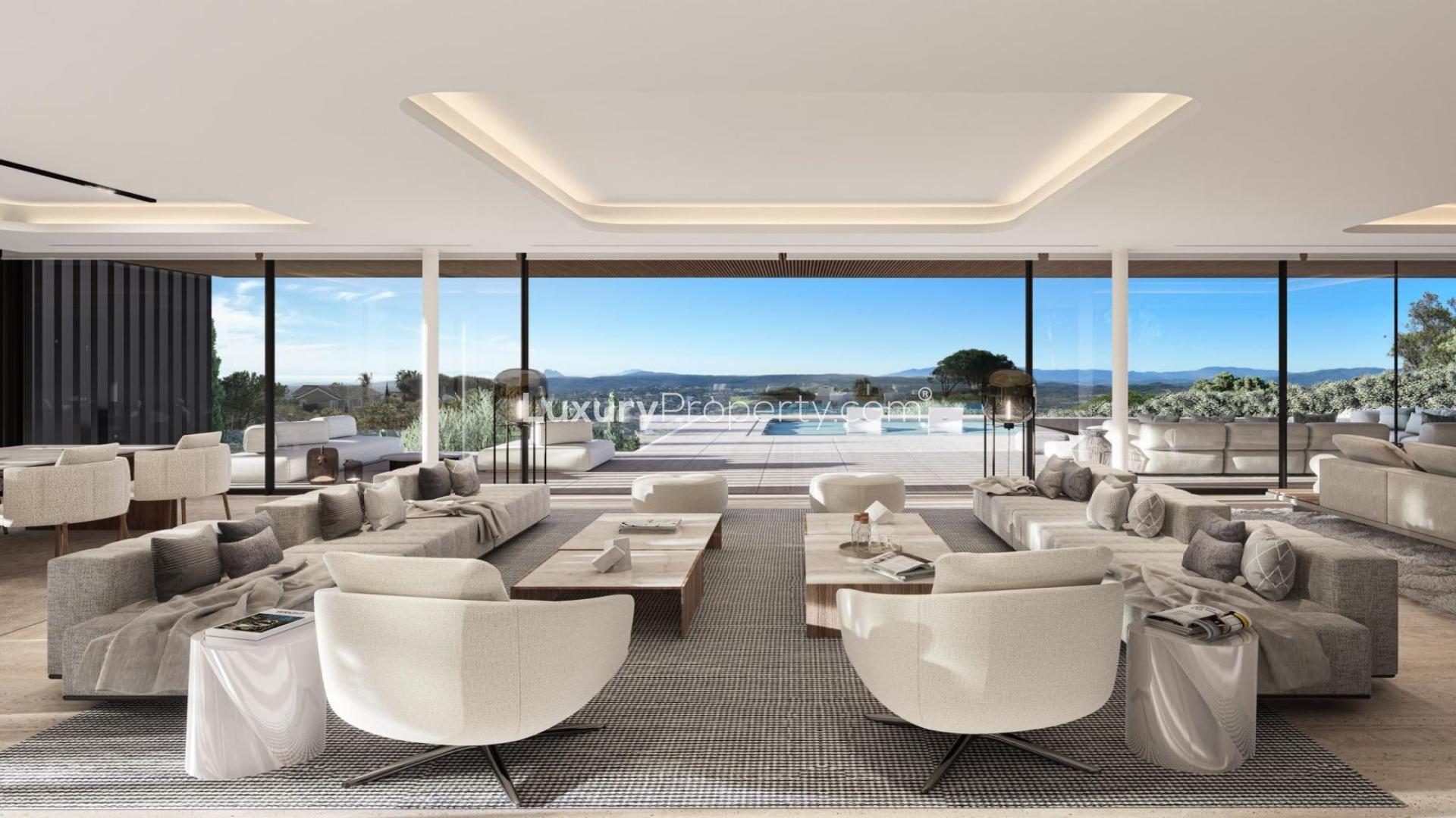 Luxurious Sotogrande villa interior with modern kitchen, spacious living area, and pool view