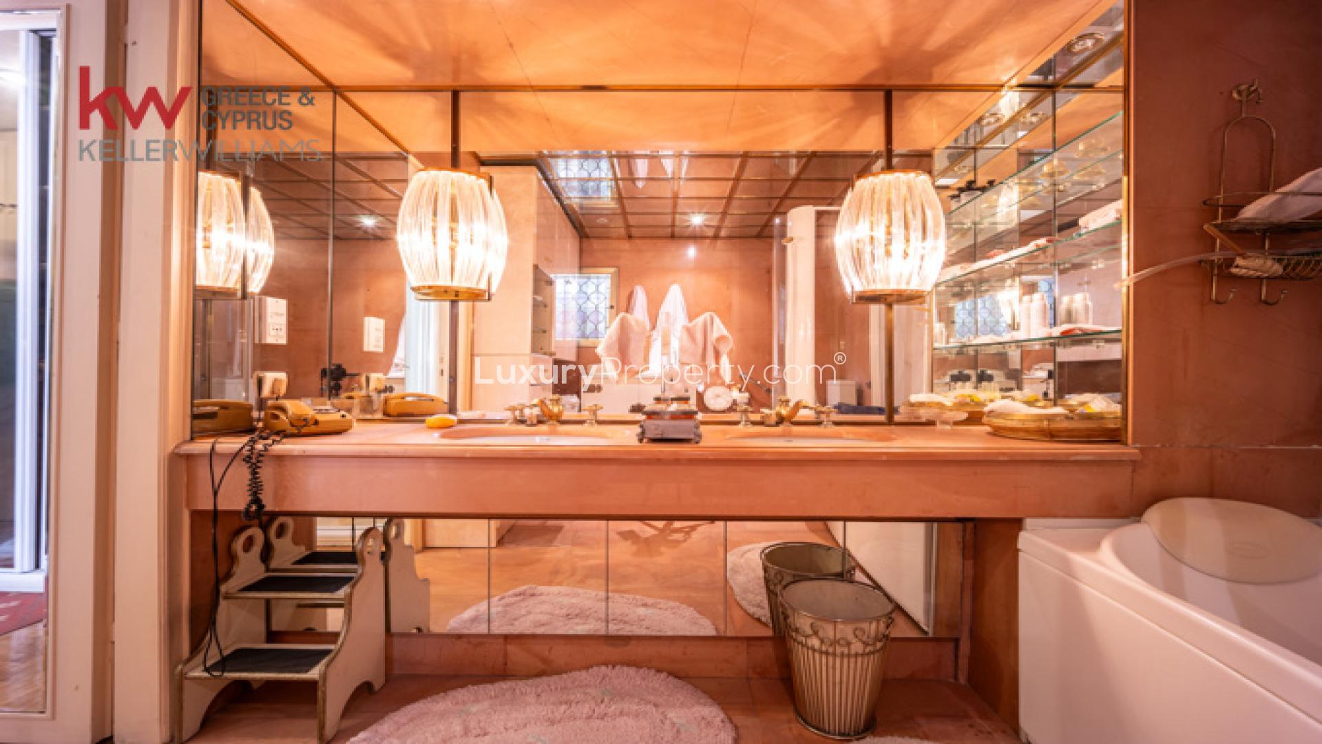 Luxurious Kolonaki apartment bedroom with chandelier, balcony view, and elegant decor