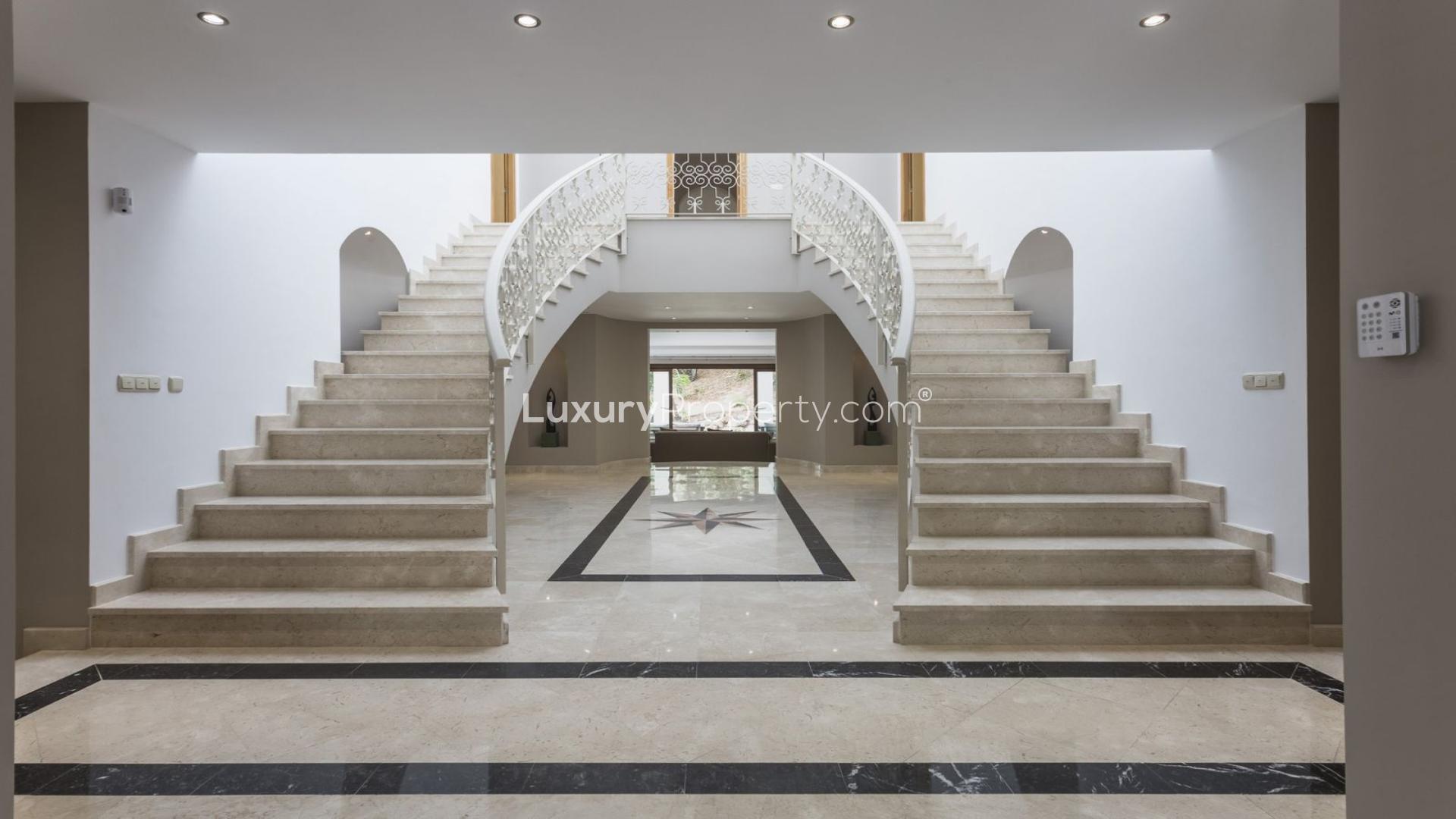 Luxurious 7-bedroom villa exterior in El Madroñal, Benahavís, surrounded by palm trees