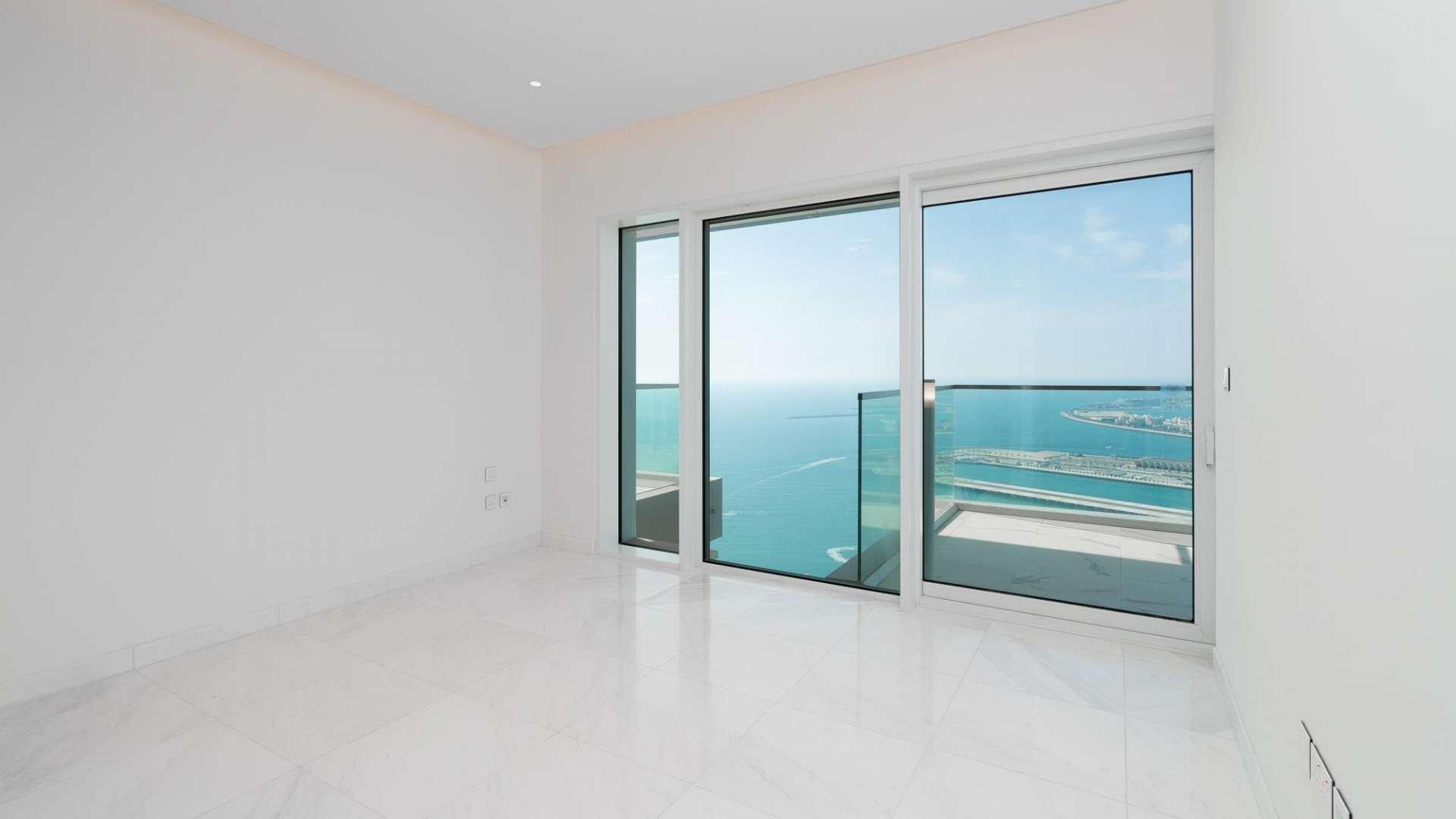 "Bright living room with ocean view in ONE JBR apartment, Jumeirah Beach Residence.","Bright apartment interior with ocean view from ONE JBR, Jumeirah Beach Residence balcony.",Bright modern kitchen in ONE JBR apartment with ocean view, Jumeirah Beach Residence