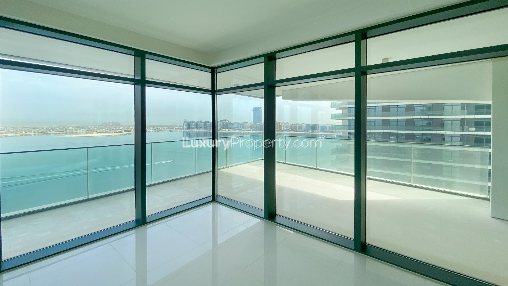 "Spacious living room with floor-to-ceiling windows in Emaar Beachfront apartment, Dubai Harbour.","Bright living room with panoramic sea views in Emaar Beachfront apartment, Dubai Harbour.","Spacious living area with large windows in Emaar Beachfront apartment, Dubai Harbour.",Modern kitchen in beachfront apartment at Emaar Beachfront, Dubai Harbour, available for rent