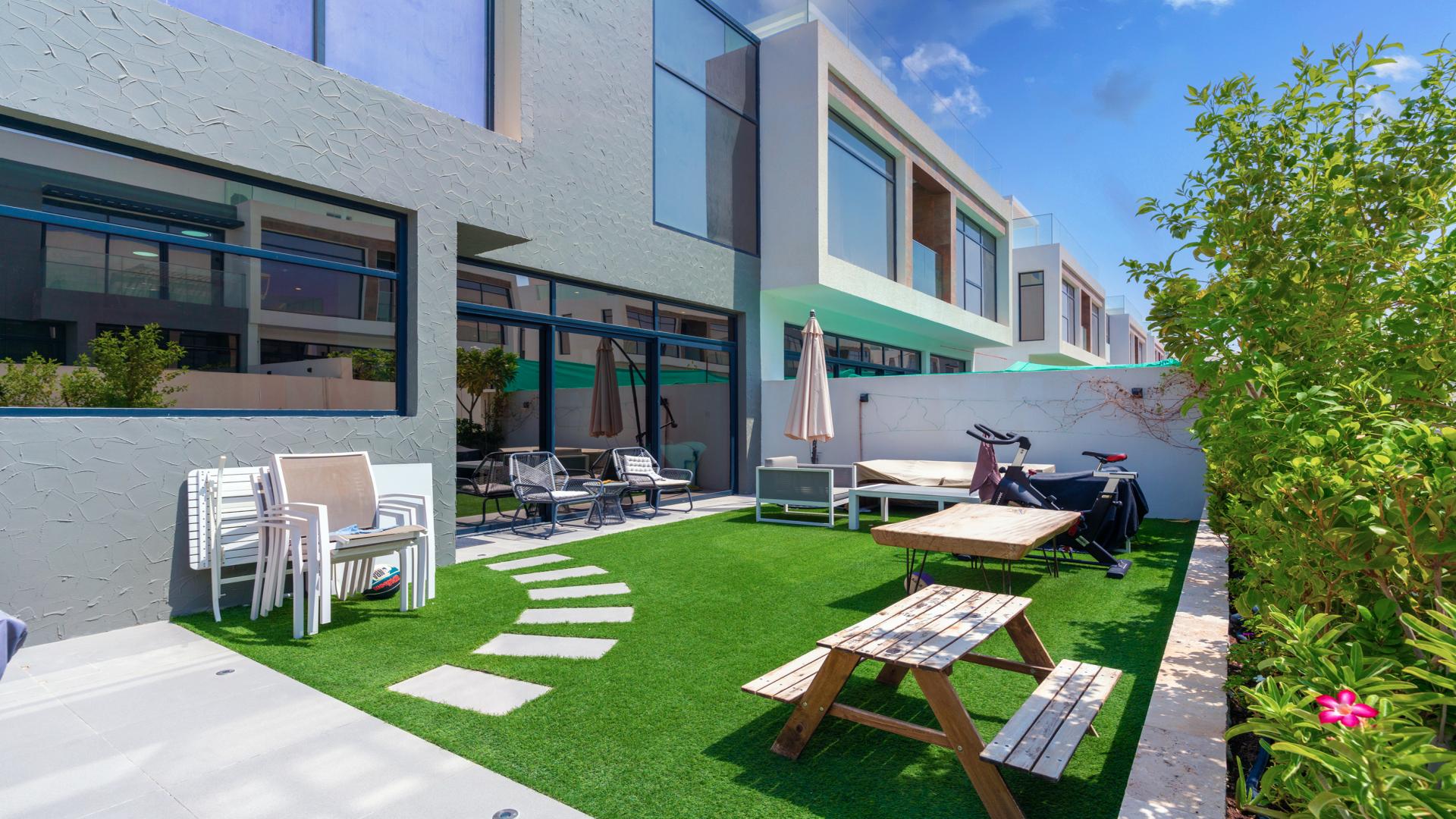 Modern living room in upgraded smart villa, Jumeirah Golf Estates, open layout with garden view