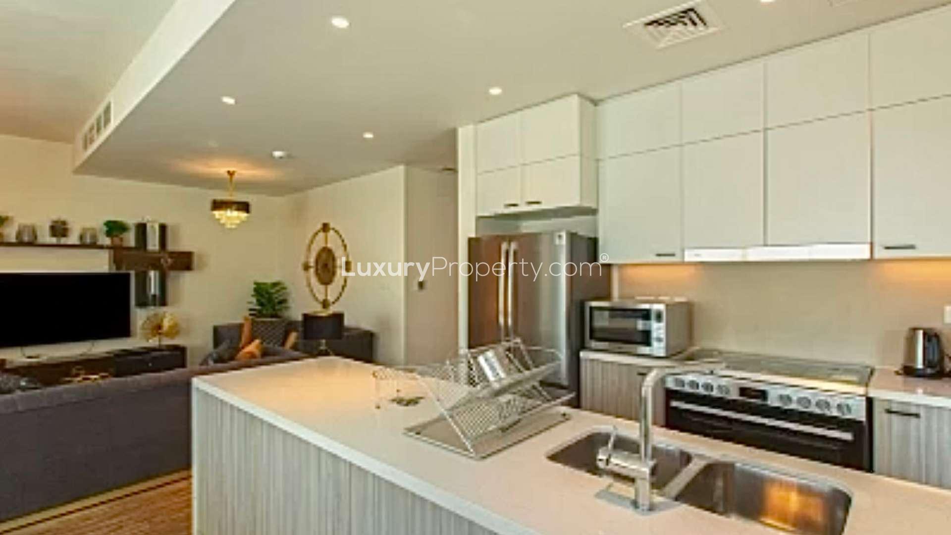 Dubai Hills Estate villa with patio, green lawn, and modern exterior in Club Villas