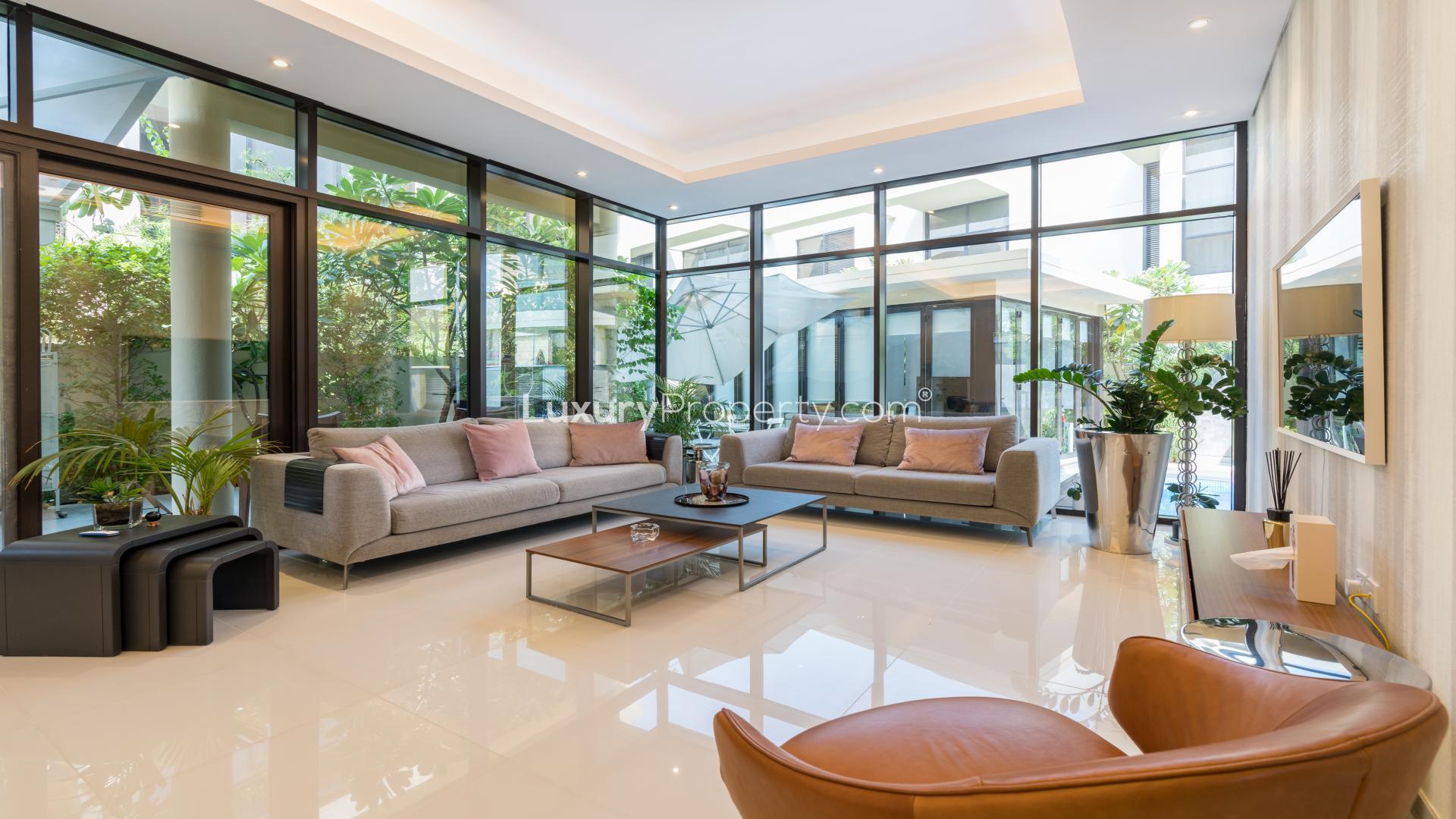 Modern townhouse exterior with carport in Rockwood, Damac Hills, available for sale