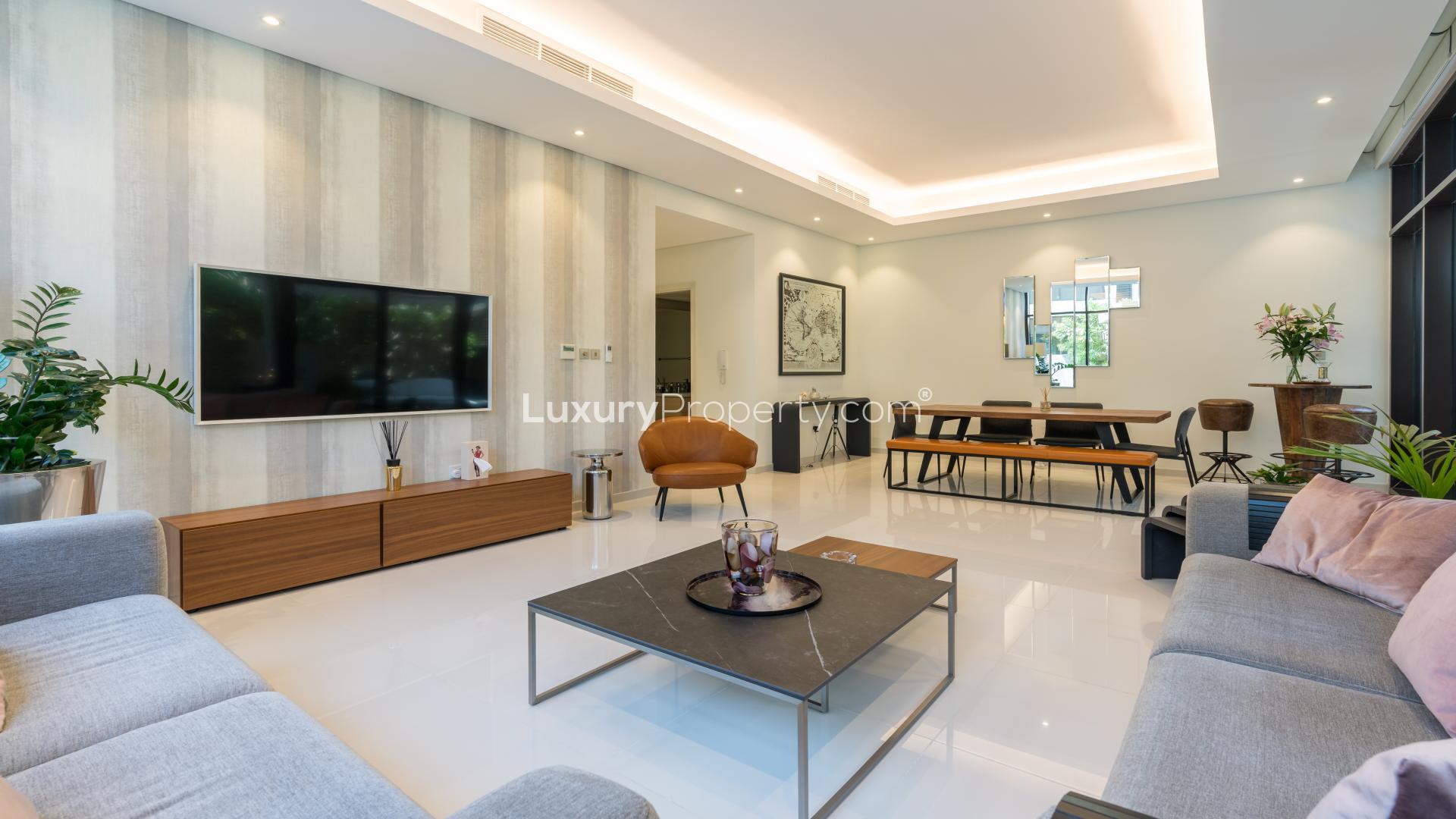 Modern living room in upgraded Damac Hills townhouse, Rockwood community, with garden view