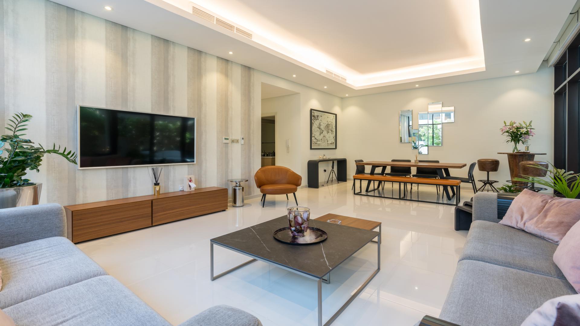 Modern living room in upgraded Damac Hills townhouse, Rockwood community, with garden view