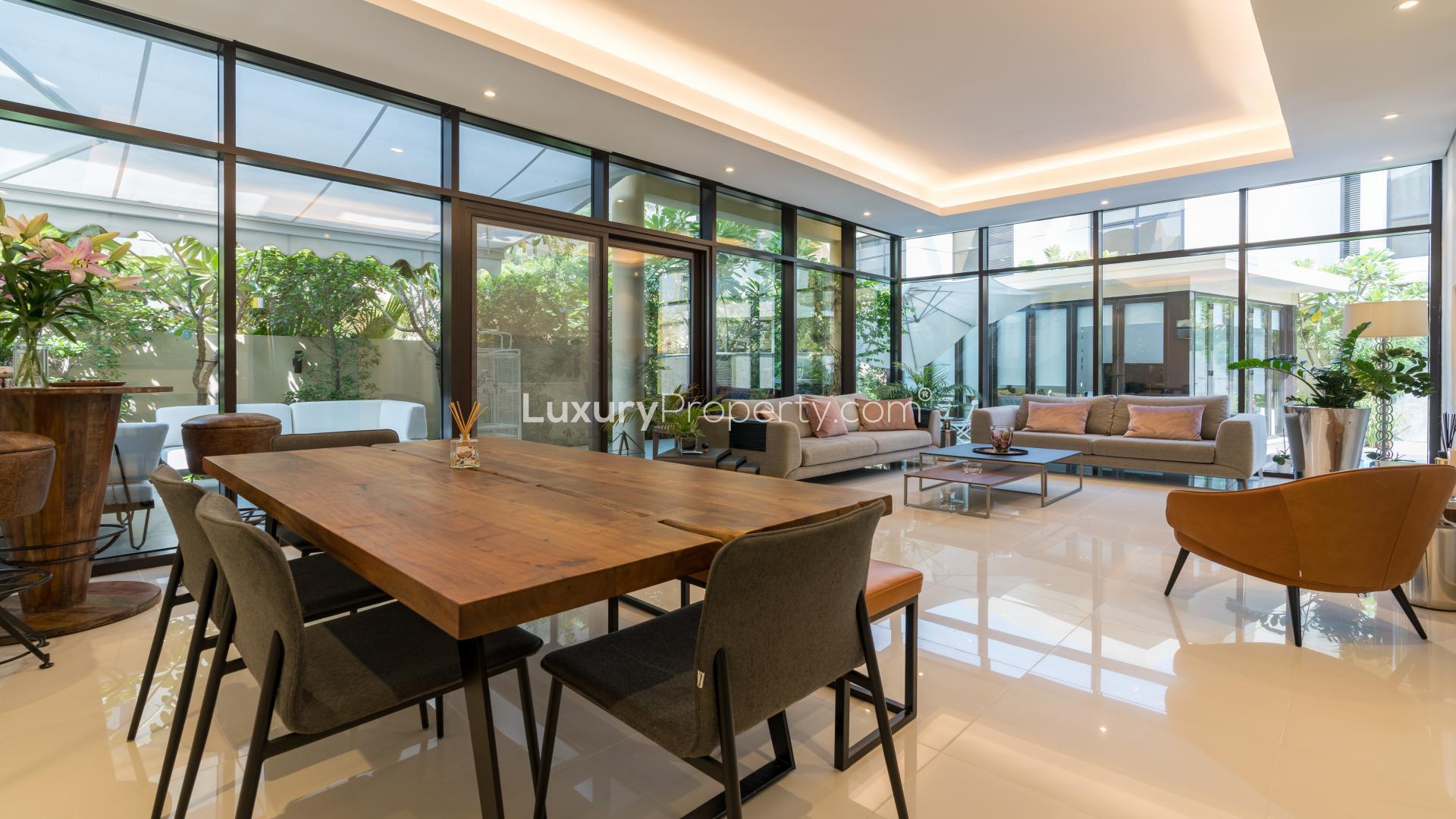 Luxurious living room in Damac Hills townhouse with modern decor and large windows