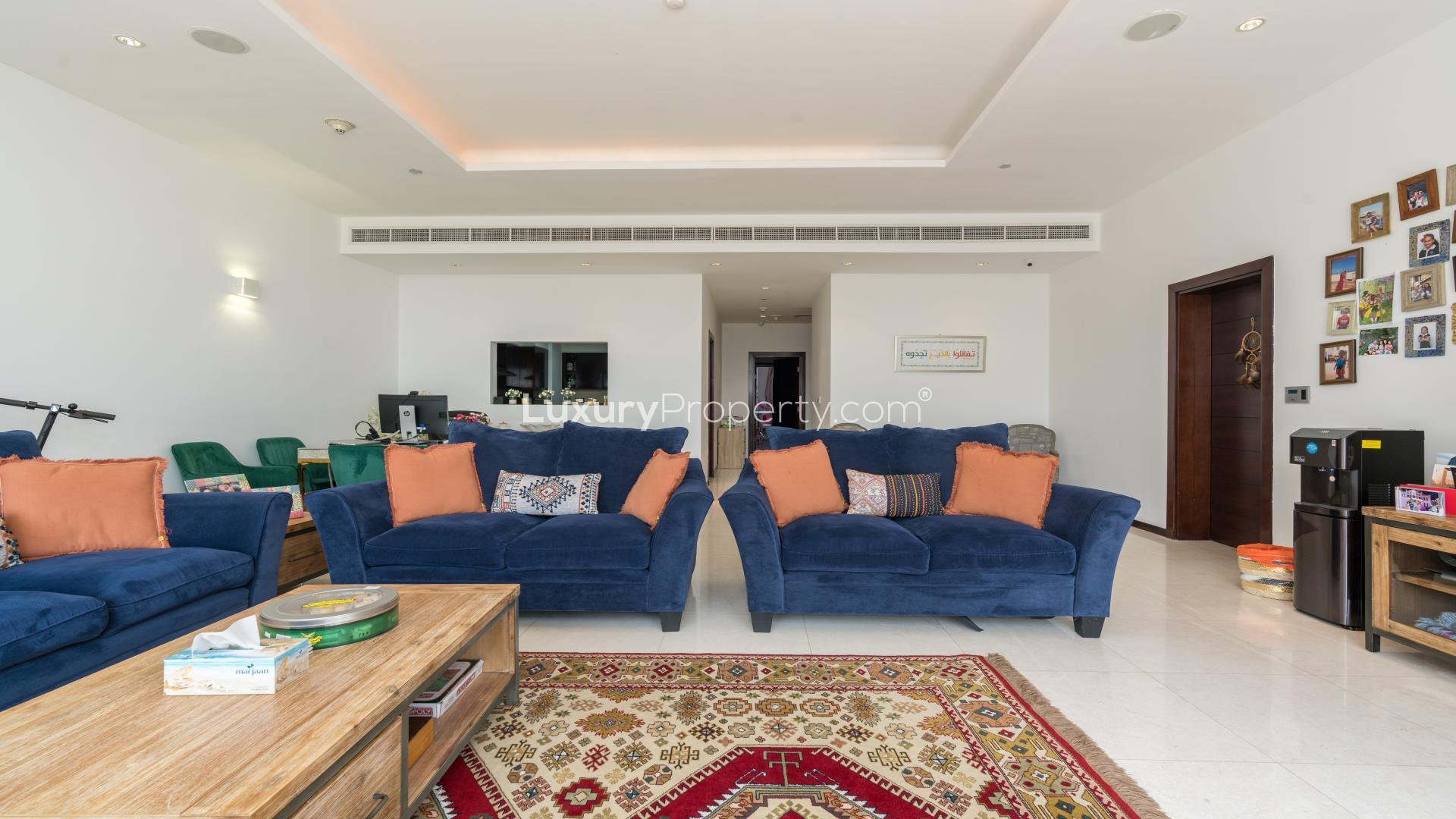 N/A,Modern living room in Tiara Residences apartment, Palm Jumeirah, with vibrant blue sofas