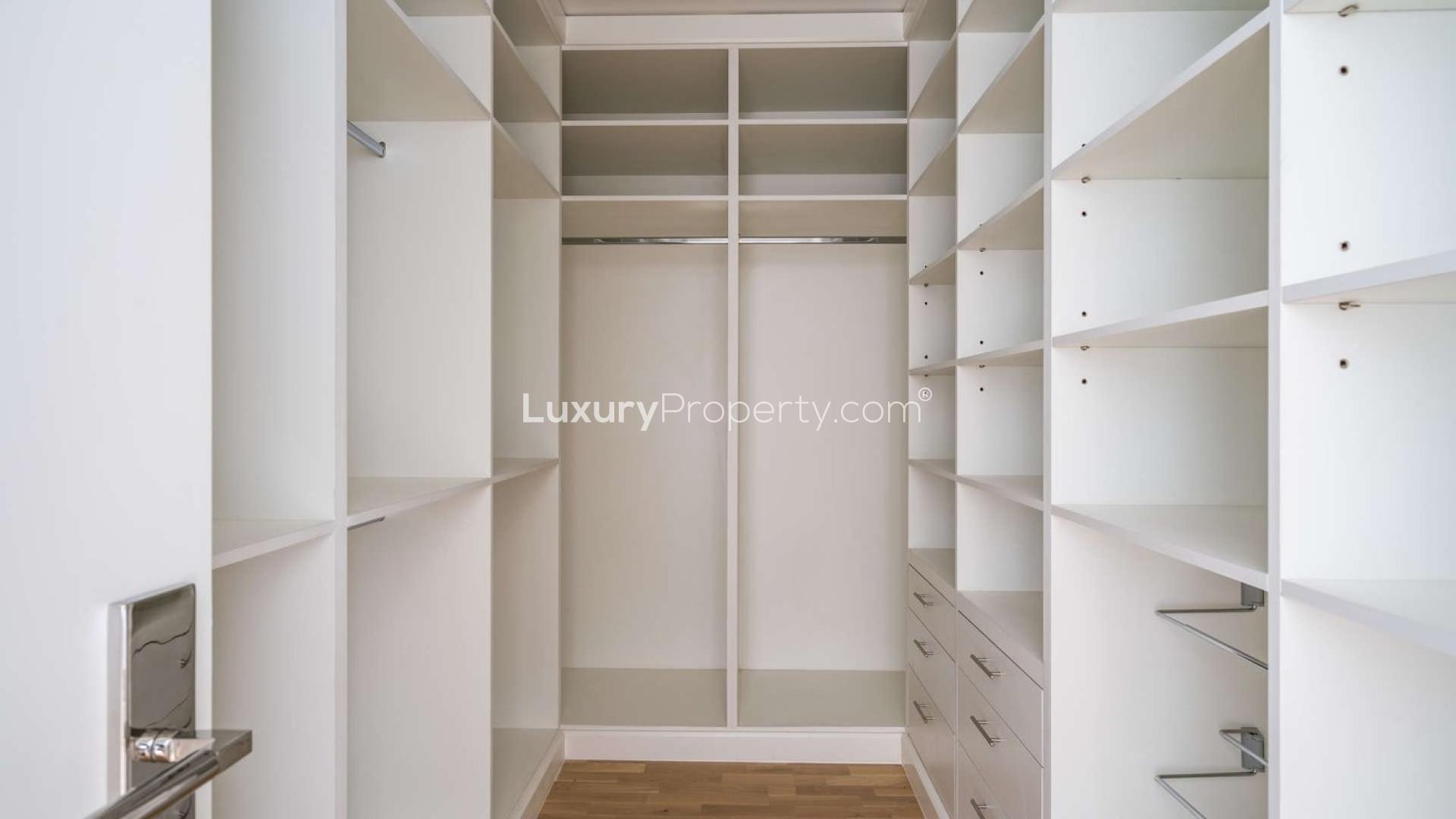 Brand new Ashjar apartment living room with large windows overlooking lush greenery in Al Barari