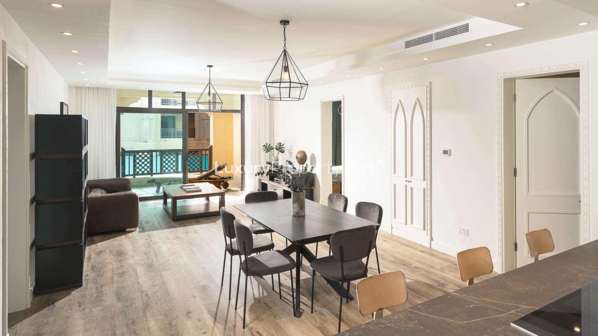 Modern living room with leather sofa, balcony view, and stylish decor in Old Town apartment