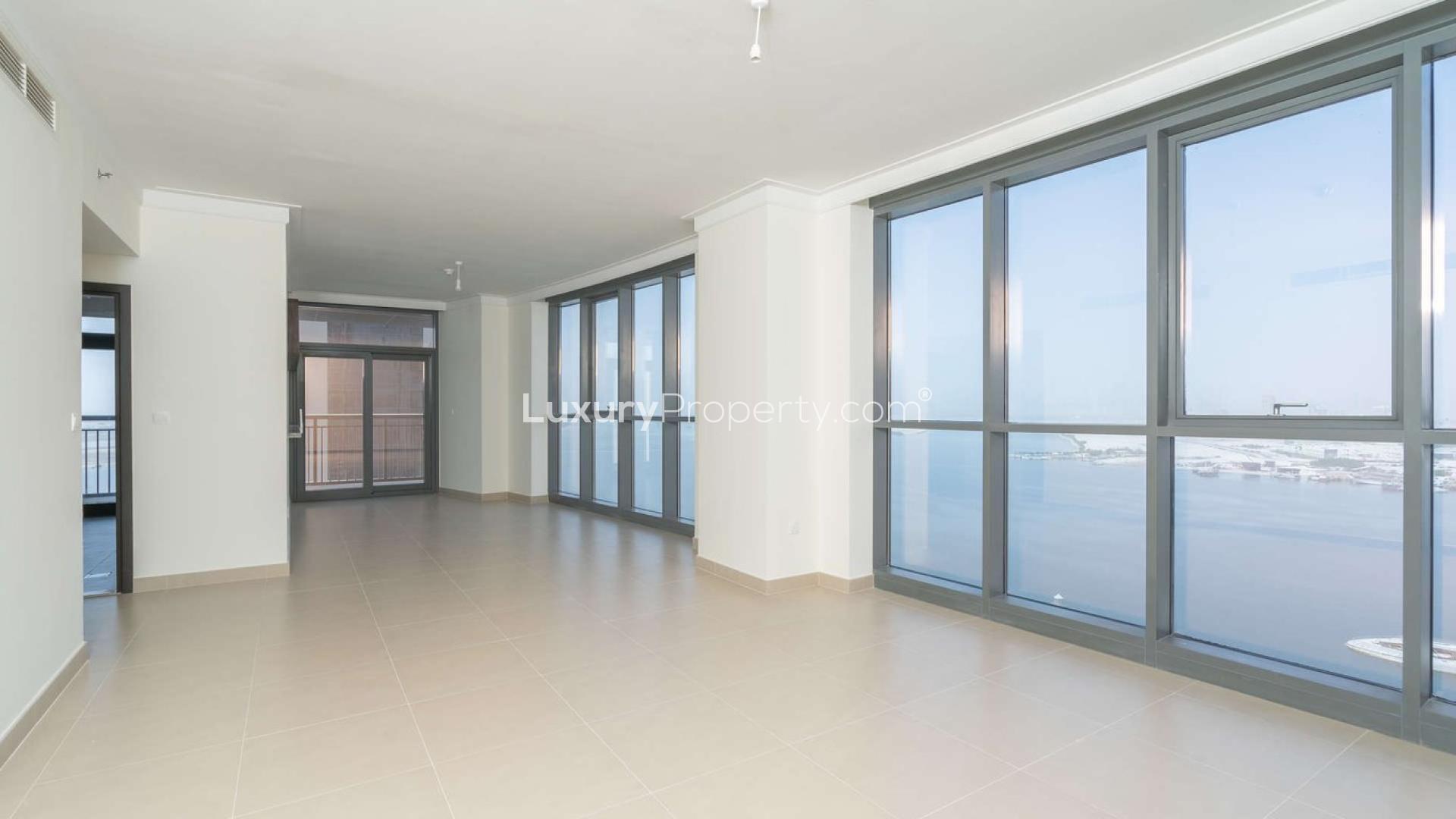 Spacious living room with large windows in Dubai Creek Harbour apartment for rent