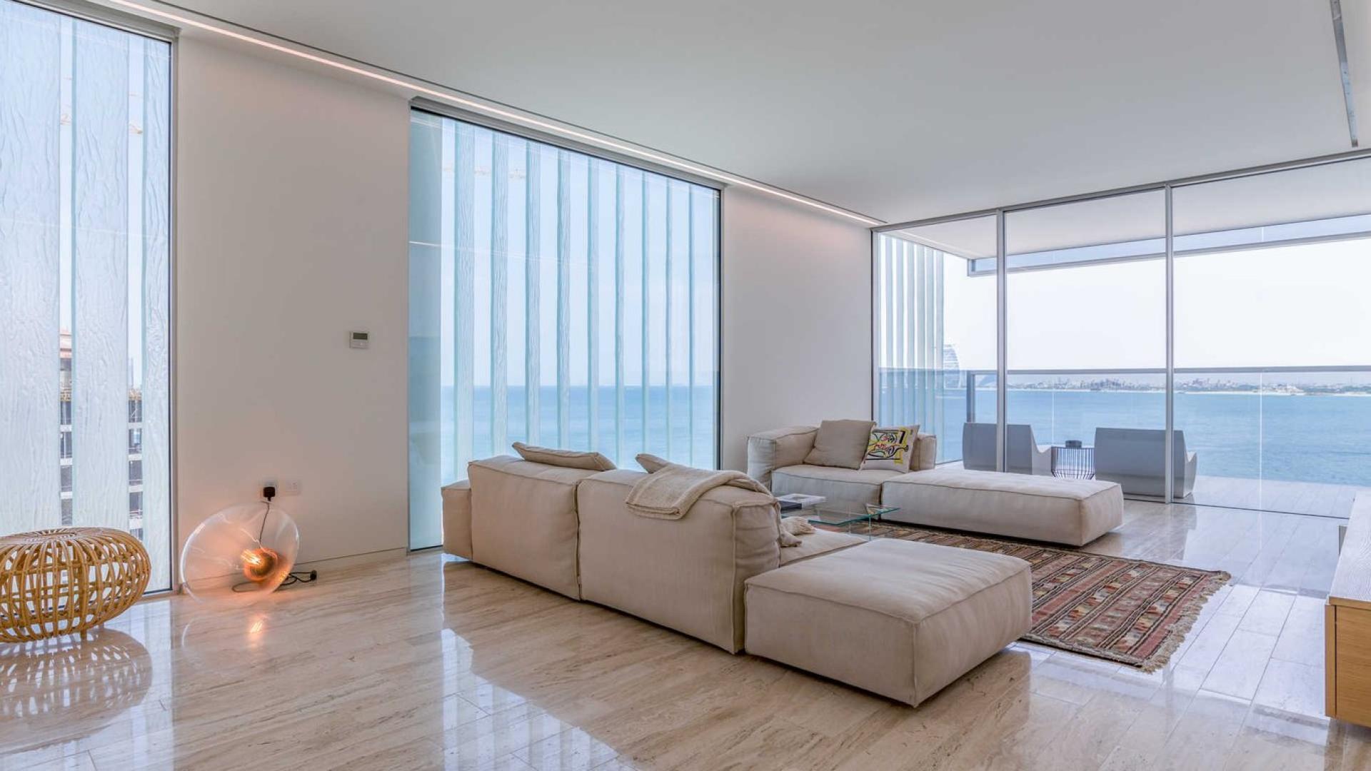 Modern living room in three-bed apartment, Muraba, Palm Jumeirah, with sea view balcony