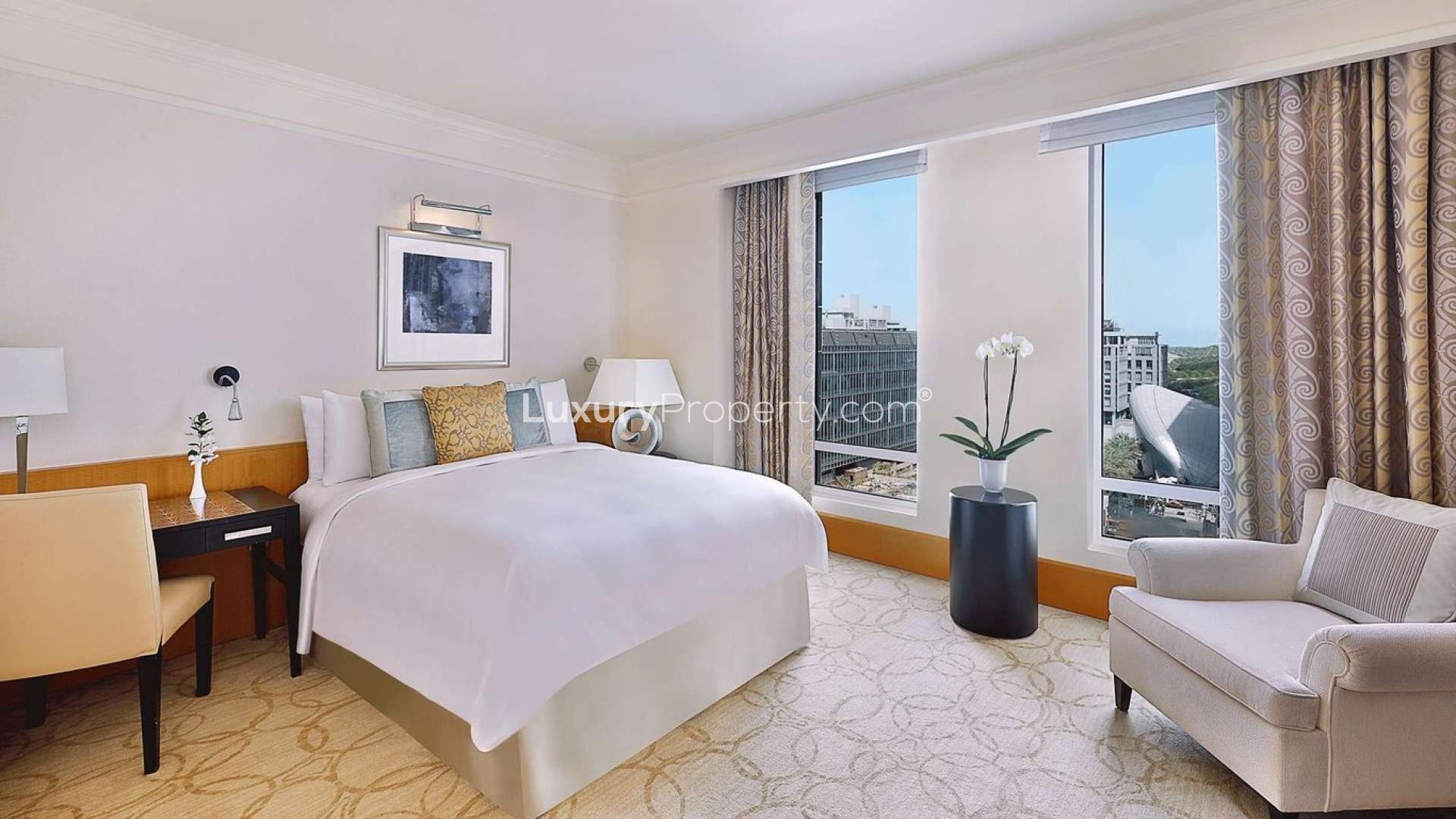 Luxurious kitchen in Ritz-Carlton DIFC apartment, featuring modern design and dining area