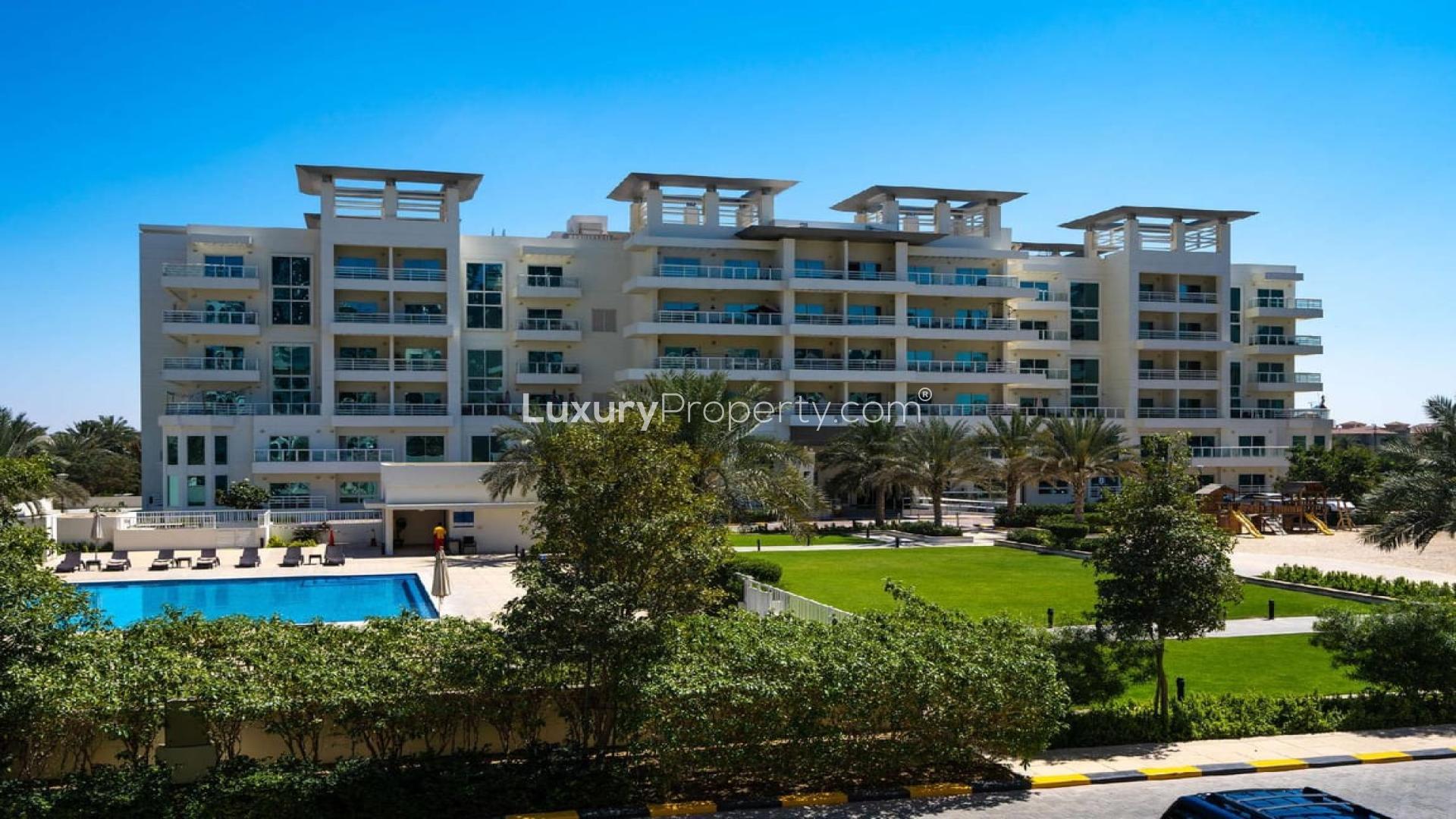 Spacious living room with modern decor and balcony view in Jumeirah Heights apartment