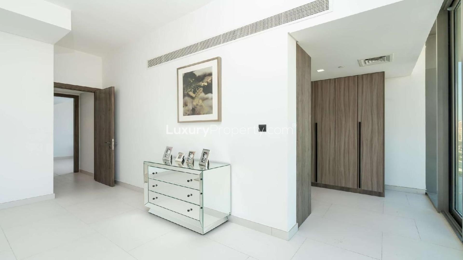"View from Soho Palm Penthouse with Burj Al Arab and Palm Jumeirah skyline.",Modern entryway of Soho Palm Jumeirah penthouse with mirrored dresser and artwork