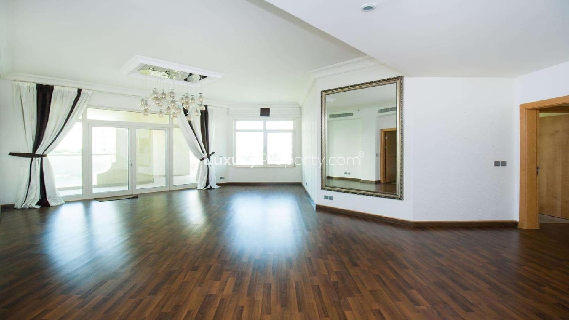 Bright living room with chandelier in Shoreline Apartments, Palm Jumeirah, available for rent