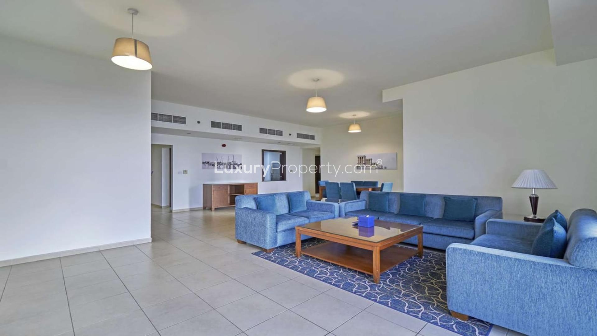 Bright living room with blue sofas in Roda Amwaj Towers apartment, JBR for rent