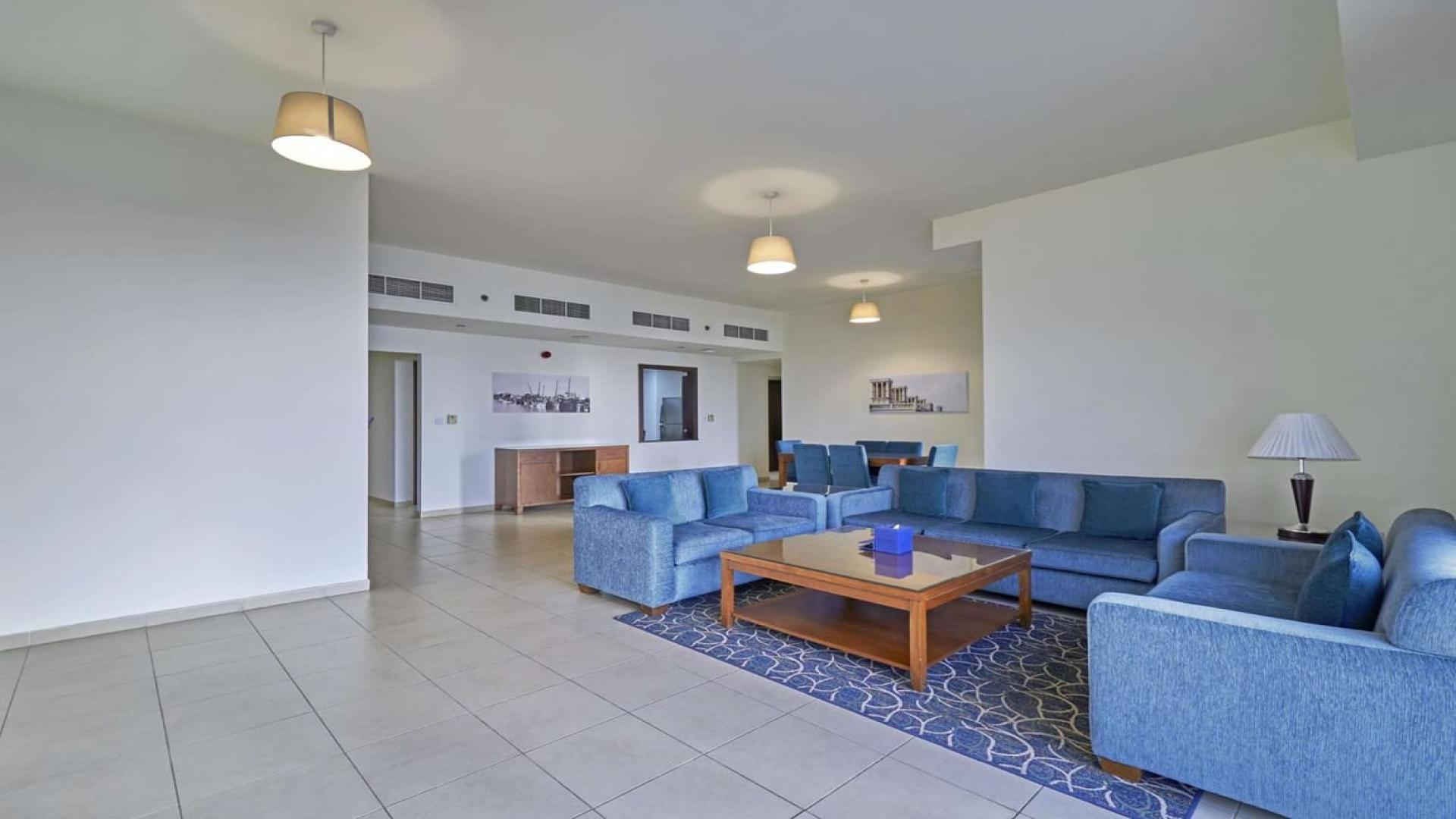 Bright living room with blue sofas in Roda Amwaj Towers apartment, JBR for rent