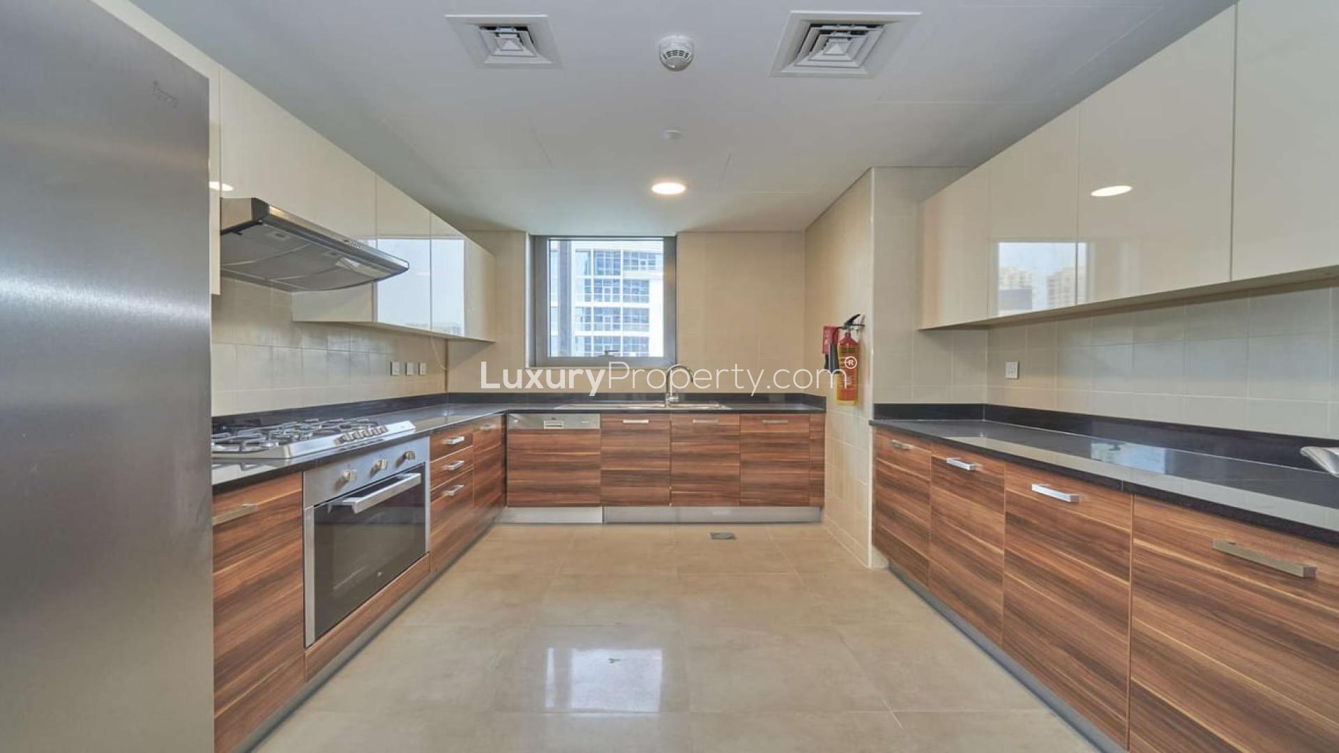 Modern kitchen in 3-bedroom apartment, Sparkle Towers, Dubai Marina, with sleek cabinetry and appliances