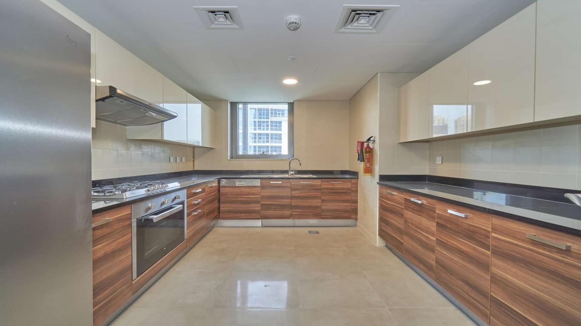 Modern kitchen in 3-bedroom apartment, Sparkle Towers, Dubai Marina, with sleek cabinetry and appliances