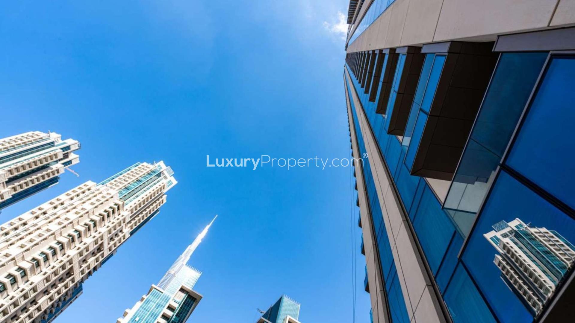 Outdoor pool at Vida Residences Downtown with stunning views of Dubai skyline and greenery