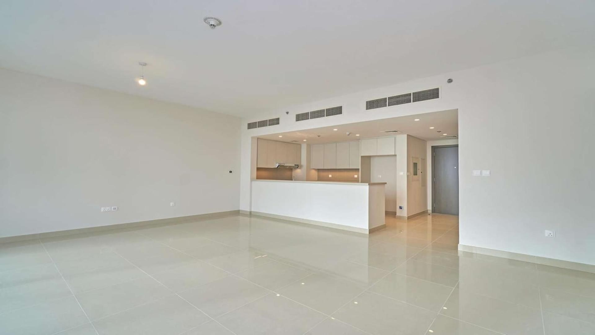 Modern open-plan kitchen and living area in Dubai Creek Harbour apartment for rent