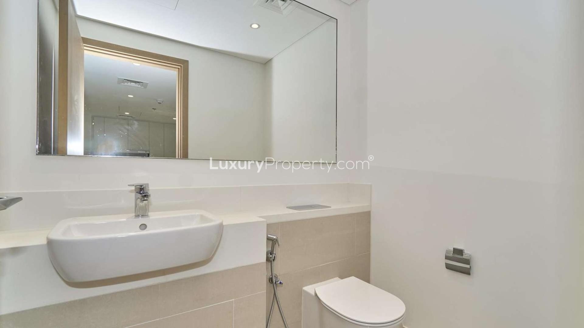 Aerial view of Dubai Creek Harbour apartment buildings and waterfront, featuring Vida Hotel