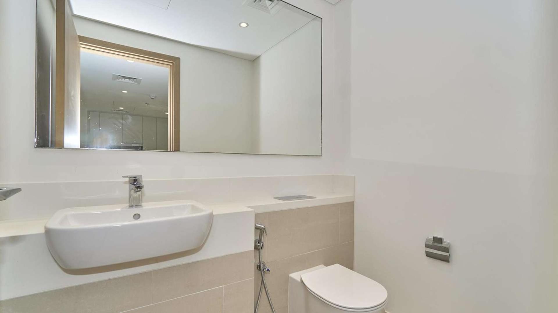 Aerial view of Dubai Creek Harbour apartment buildings and waterfront, featuring Vida Hotel