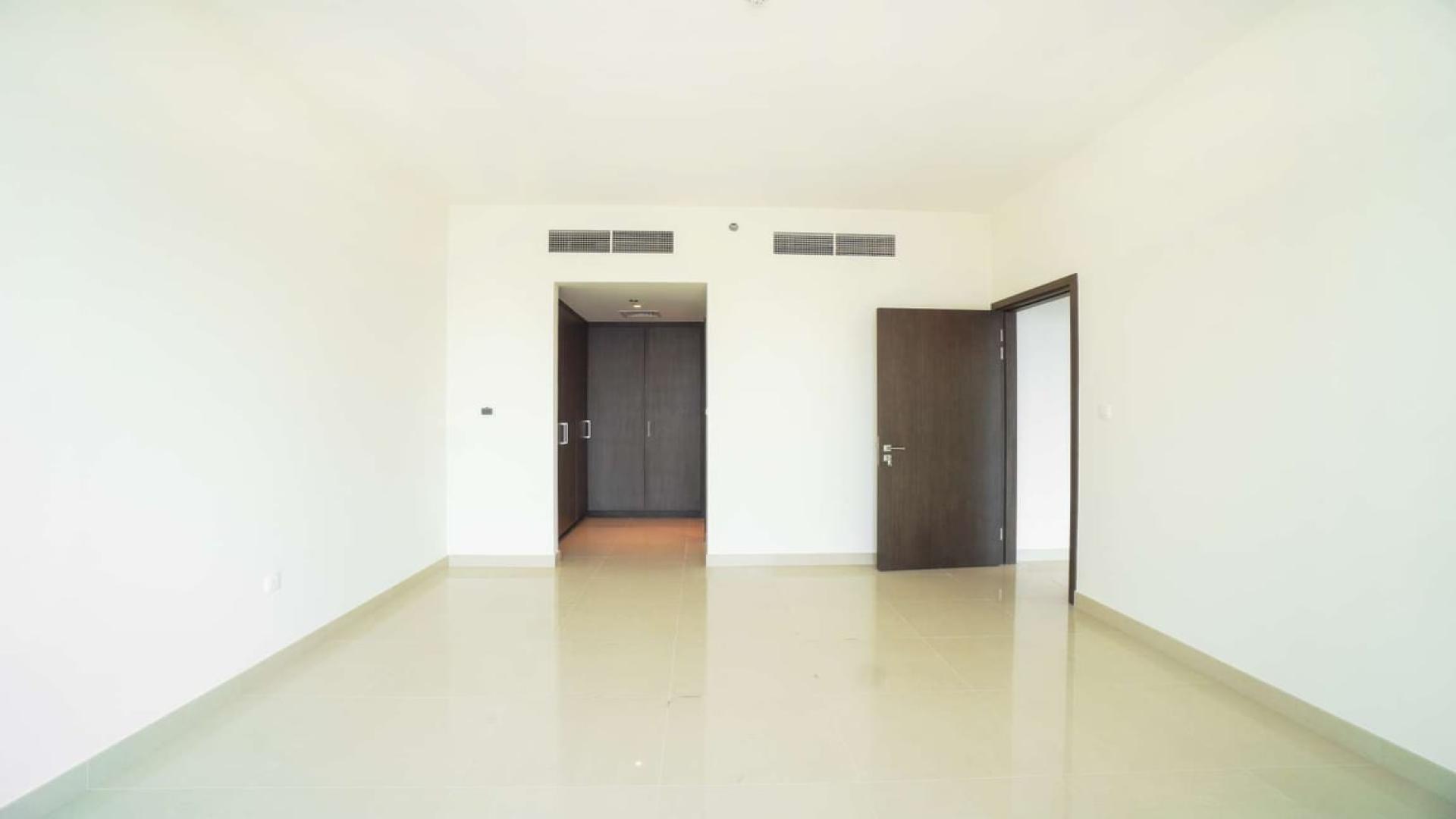 "Dubai Creek Harbour apartment view with marina, skyscrapers, and waterfront skyline, Harbour Views 1.",Empty room in three-bedroom apartment, Dubai Creek Harbour, spacious and bright interior