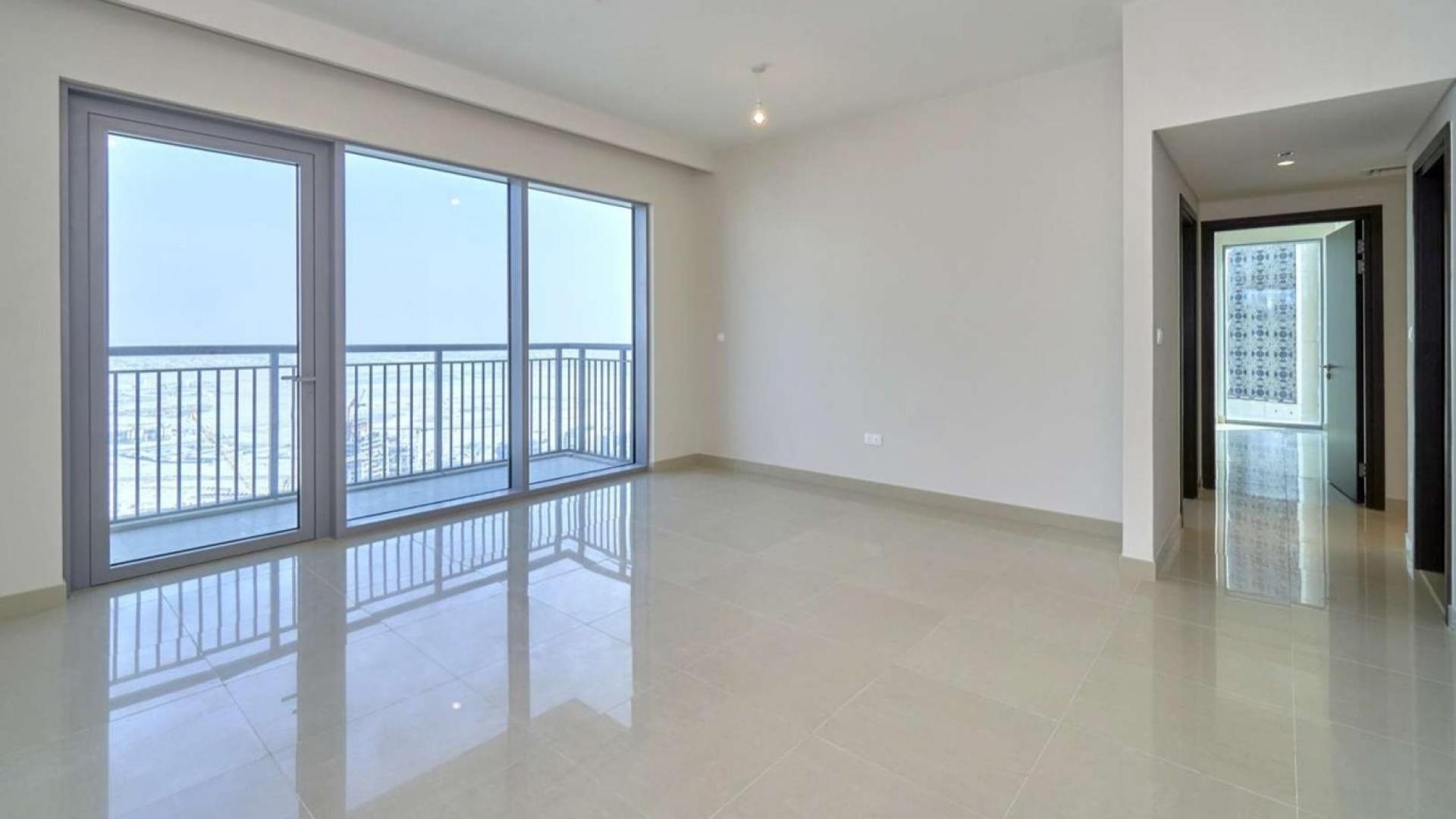 Empty living room with large windows in Harbour Views Tower 1 apartment, Dubai Creek Harbour