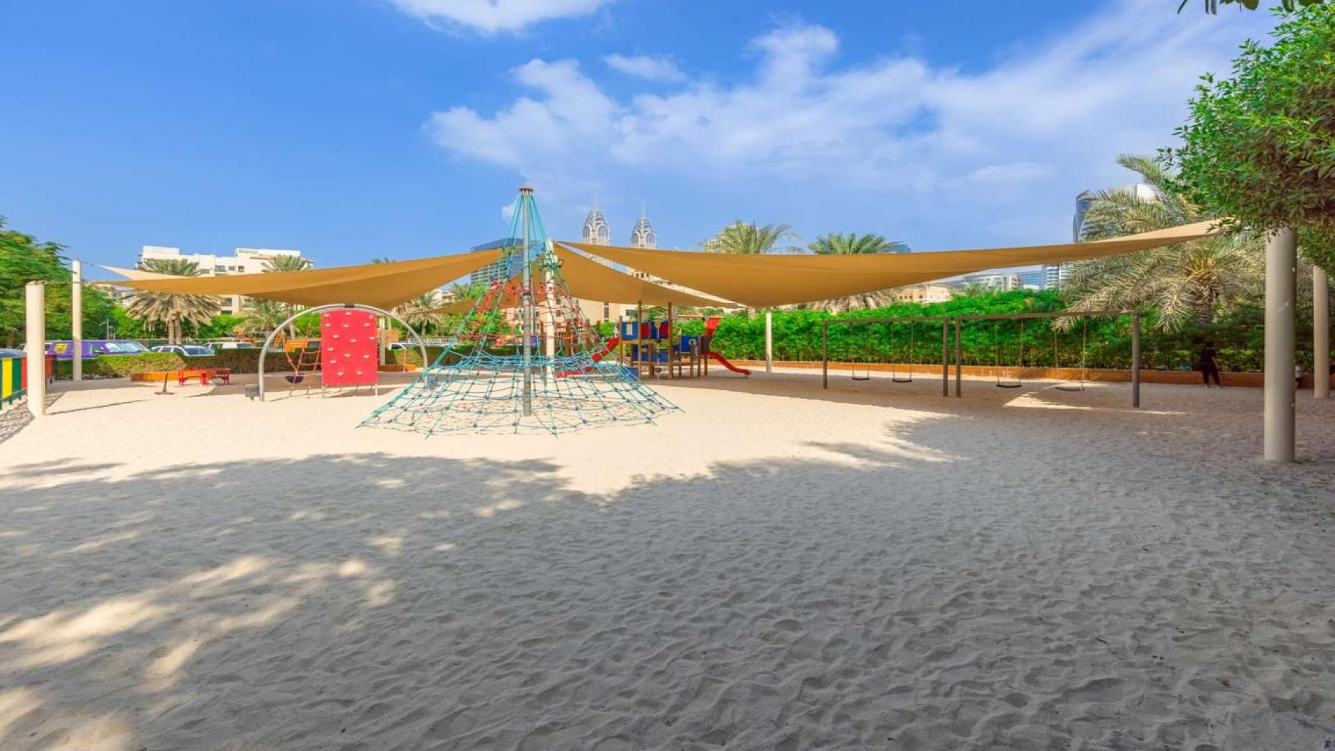 Spacious living room with large windows in The Views 2-bedroom apartment for rent