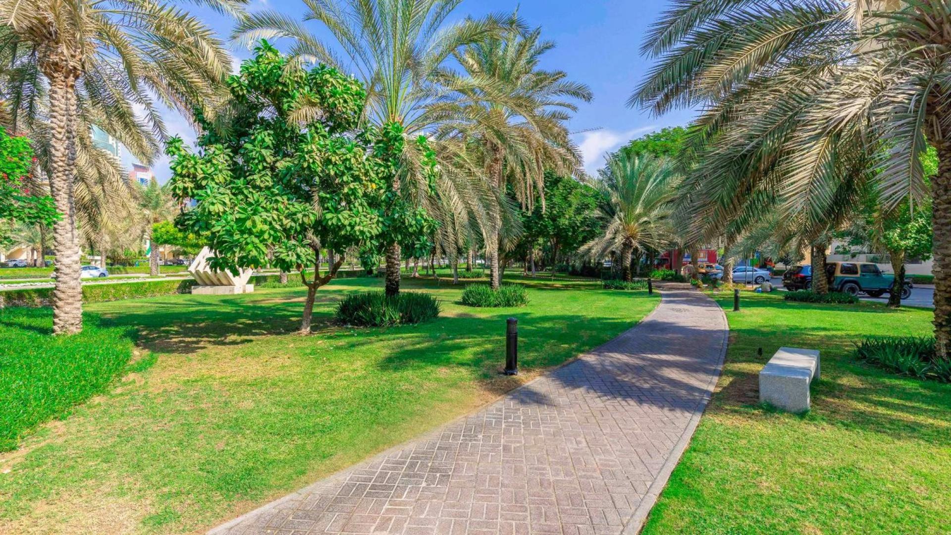 Empty living room with tiled floor and large windows in The Views apartment
