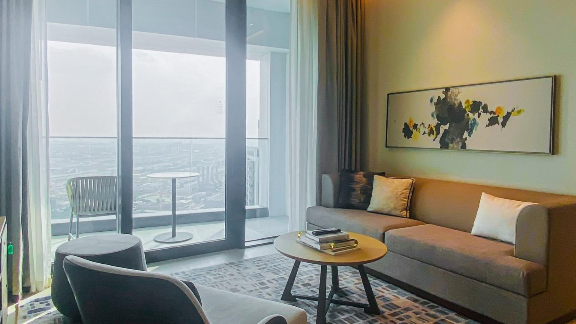 Modern living room in Jumeirah Beach Residence apartment with balcony view and stylish decor