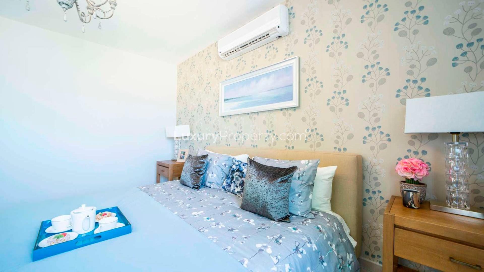 Luxurious living room and dining area in Al Andalus three-bedroom apartment, Jumeirah Golf Estates