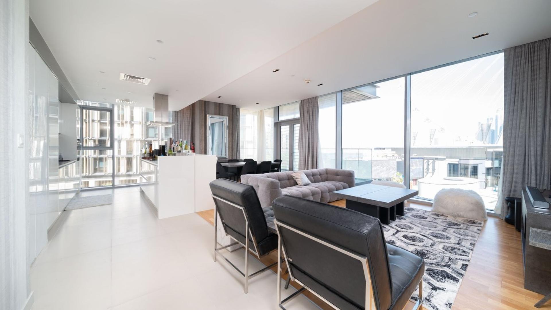 Modern living room in 3-bedroom Bluewaters Island apartment, featuring stylish furnishings and large windows