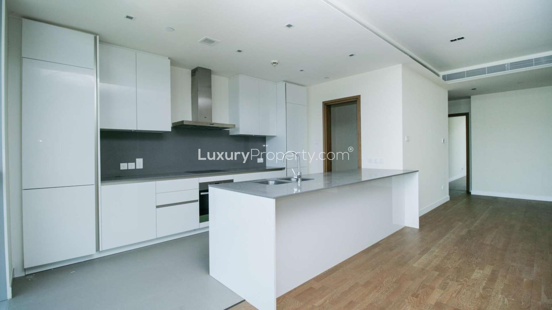 Modern open-plan living area with large windows in City Walk apartment for rent