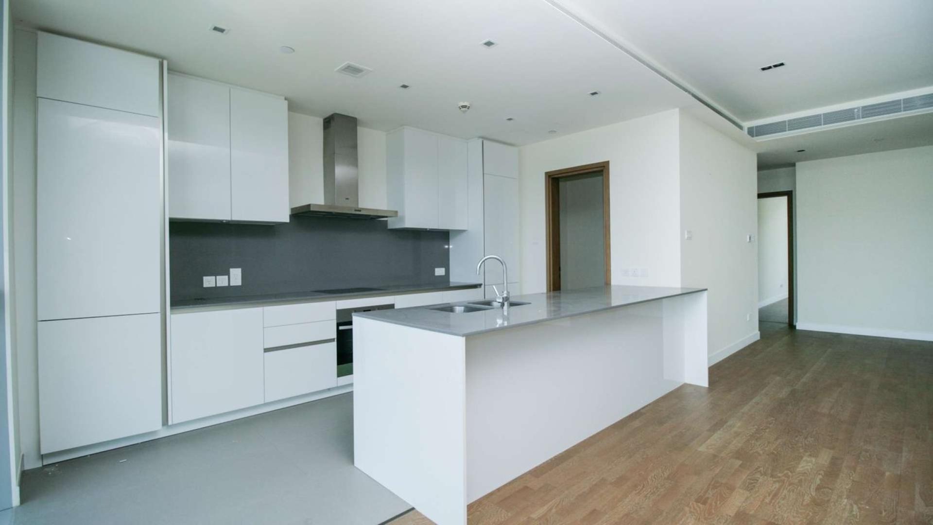 Modern open-plan living area with large windows in City Walk apartment for rent